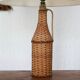bottle lamp covered with wicker, white drum lampshade, 70s