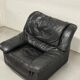 Vintage black leather lounge chair — low postmodern club chair from the space age.