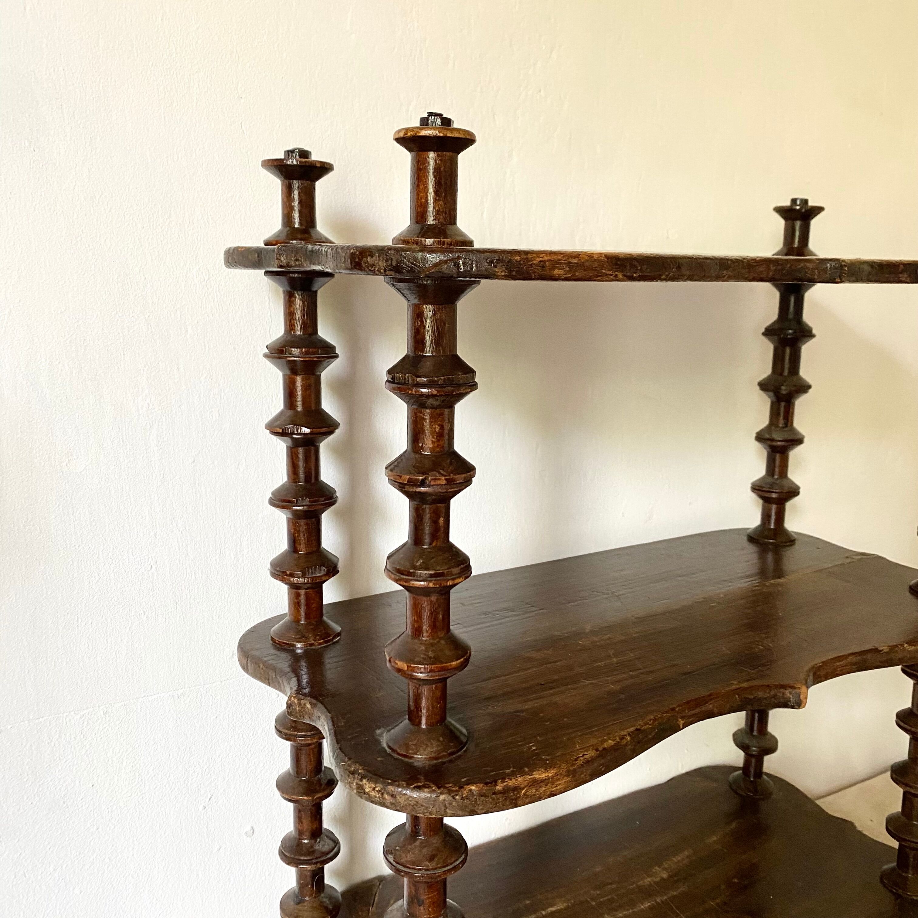 Old shelf in turned wood like reels