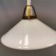 A set of hanging lamps in milky white opal glass with brass top.