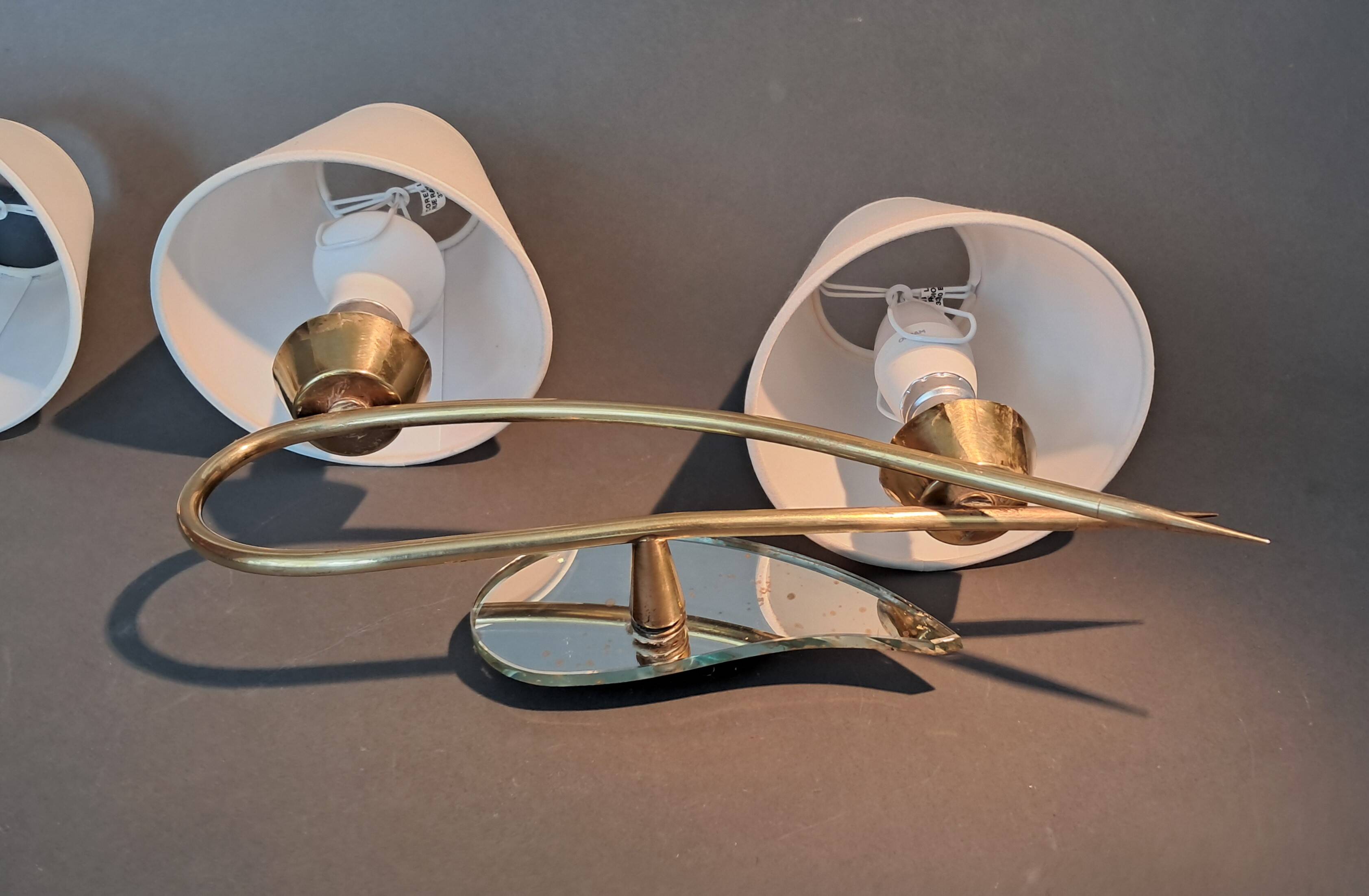 Pair of gilded brass and mirror wall lights, Circa 1960.