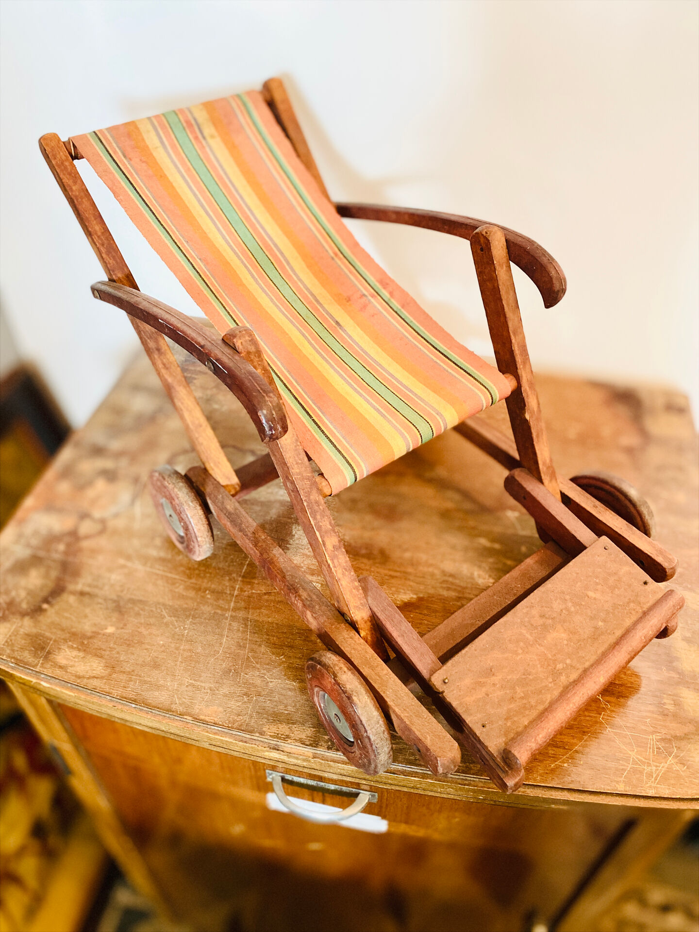 Vintage wooden folding doll's deckchair on wheels