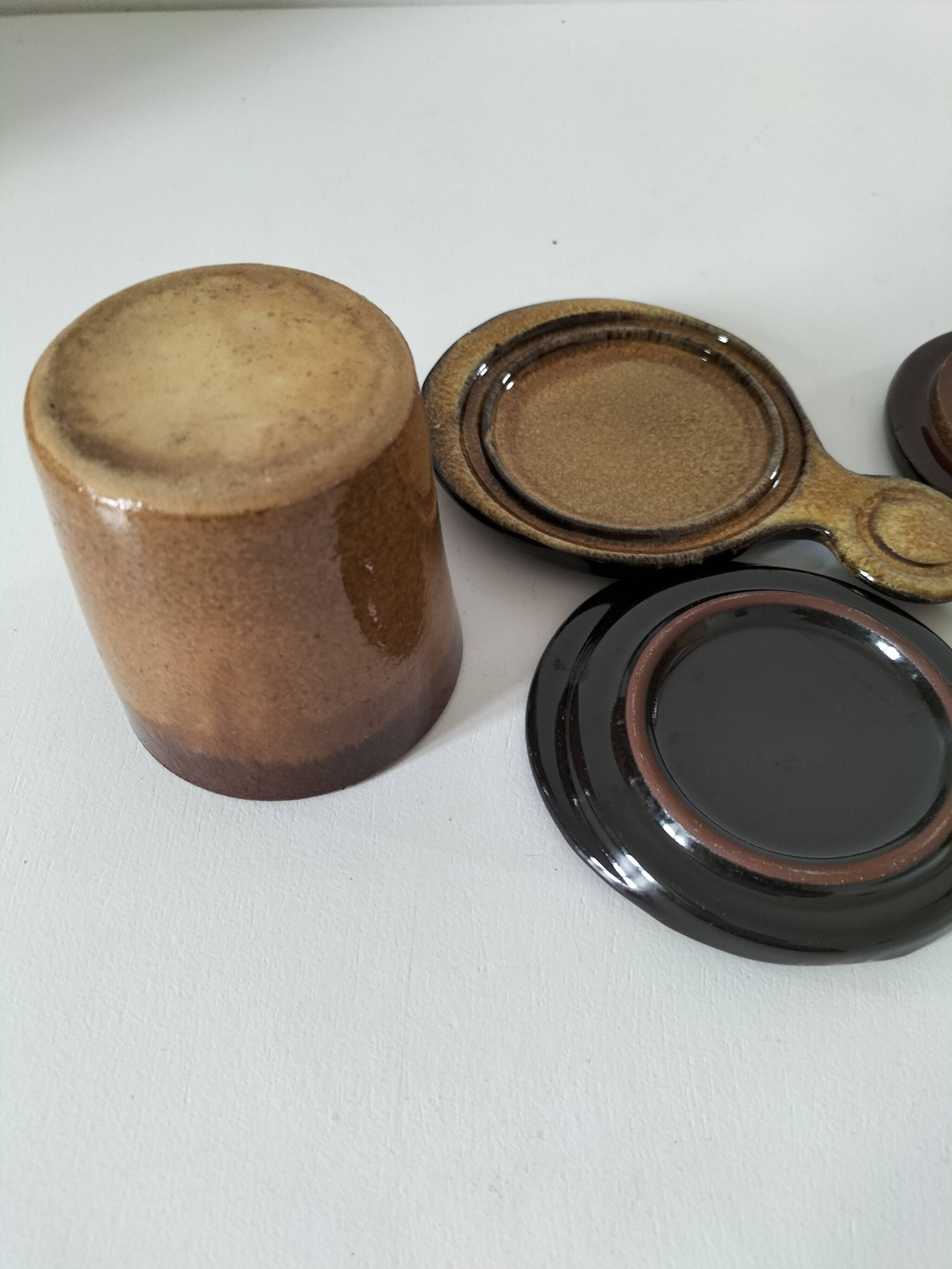 Pair of glazed stoneware cups with saucers and lids