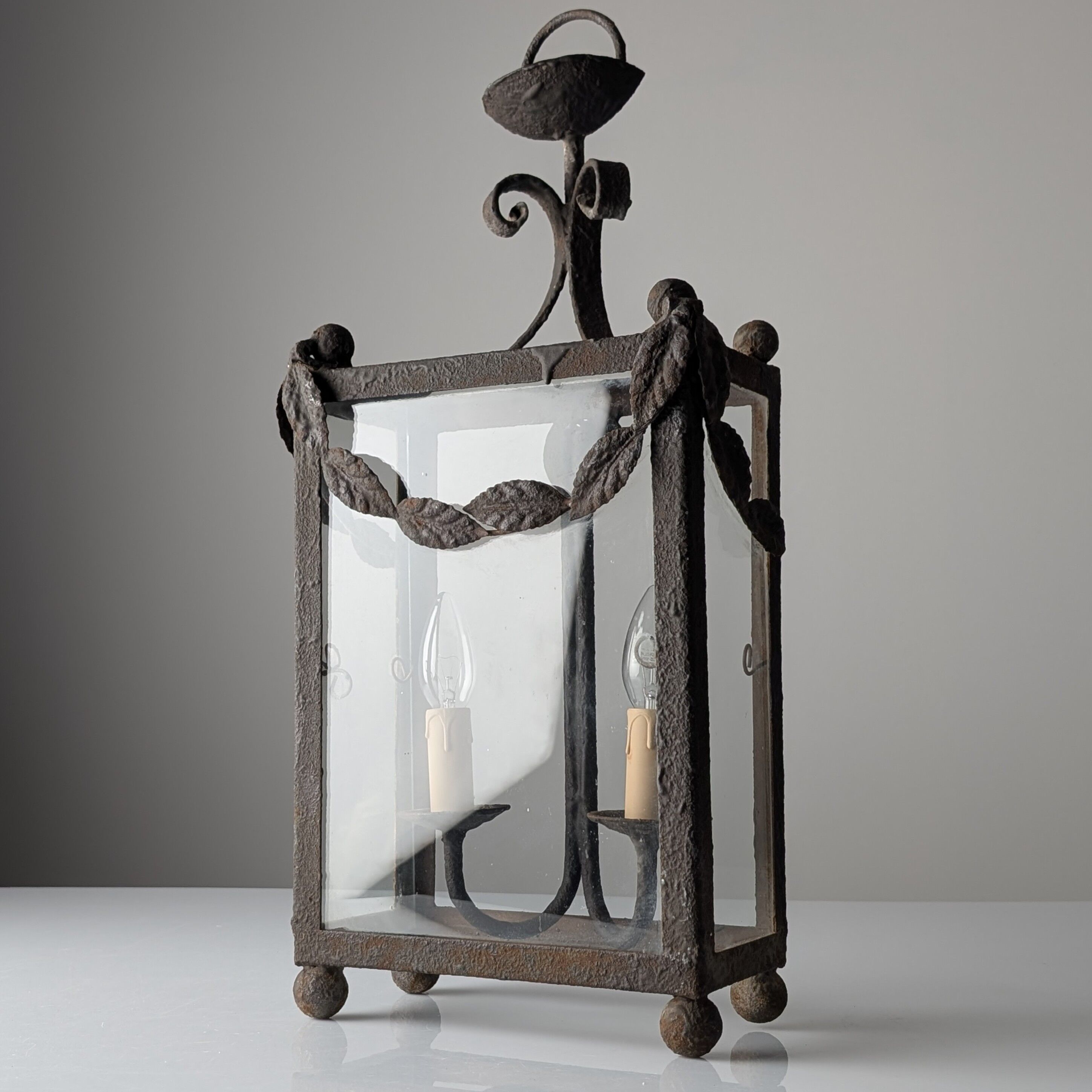 Wrought iron lantern with glass panels, leaf motifs