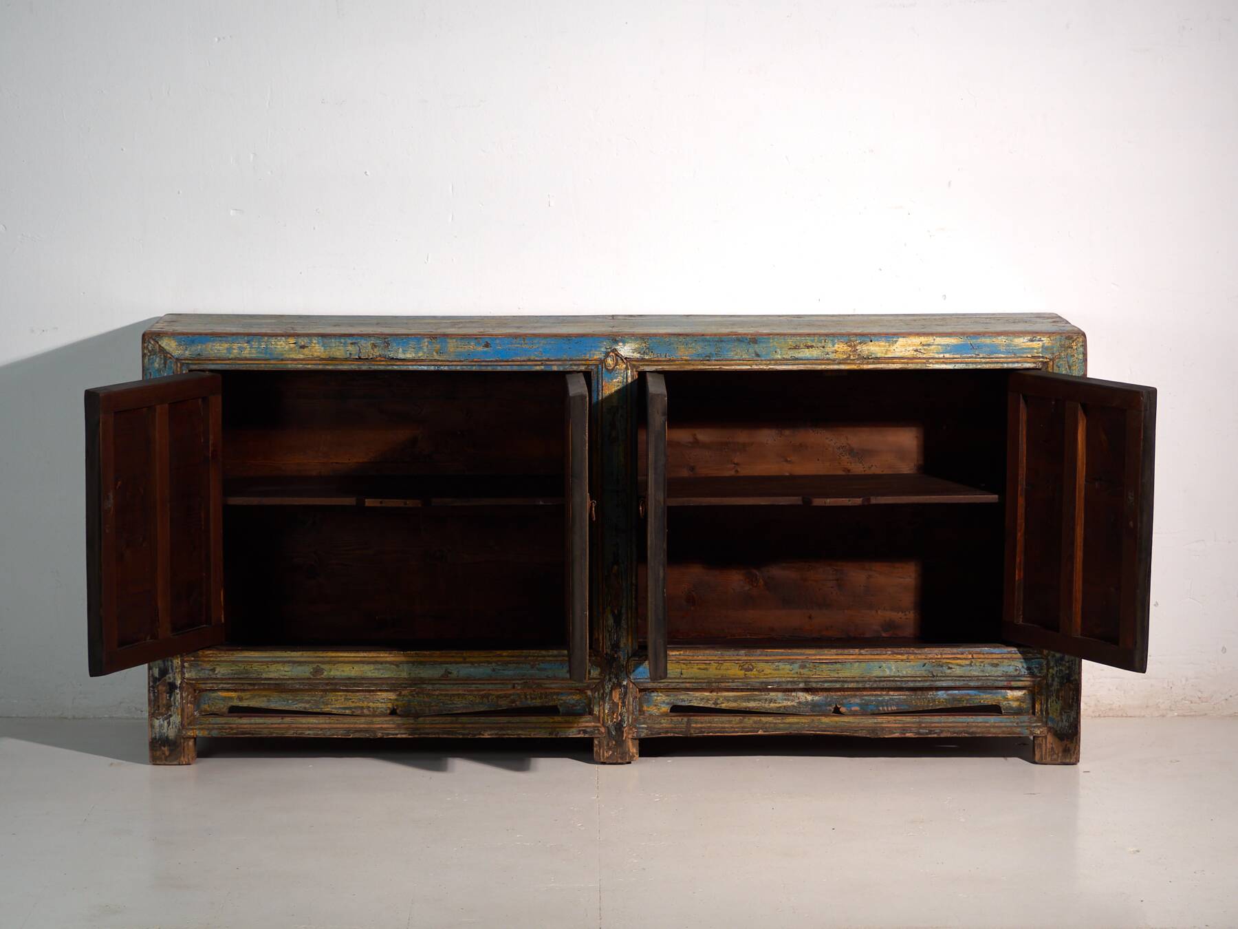 Old wooden entrance buffet in blue and yellow tones (circa 1920).