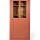 Antique glass-fronted terracotta cupboard