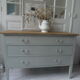 Green green vintage chest of drawers of gray, wood top.