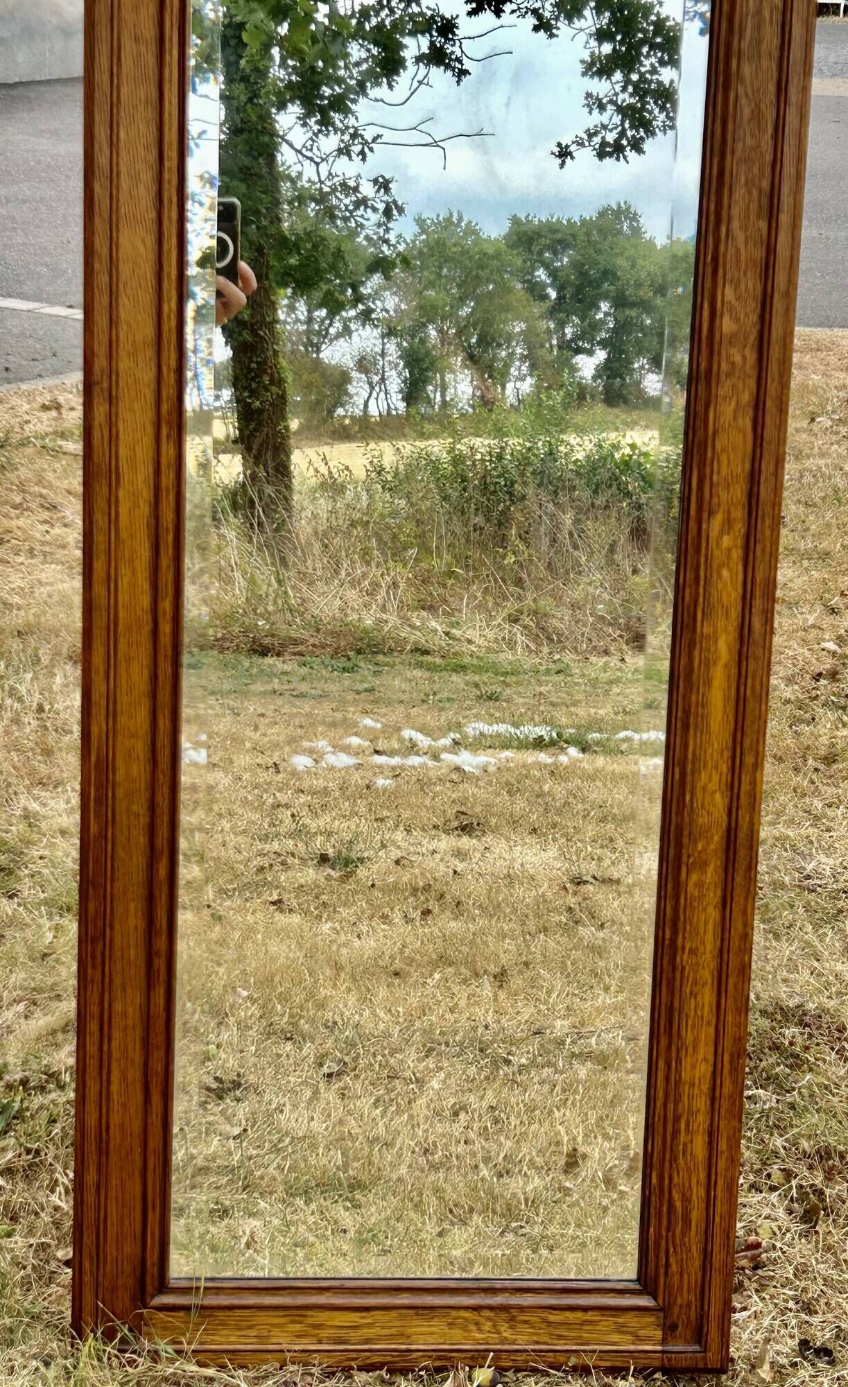 Large and old bevelled framed floor mirror.