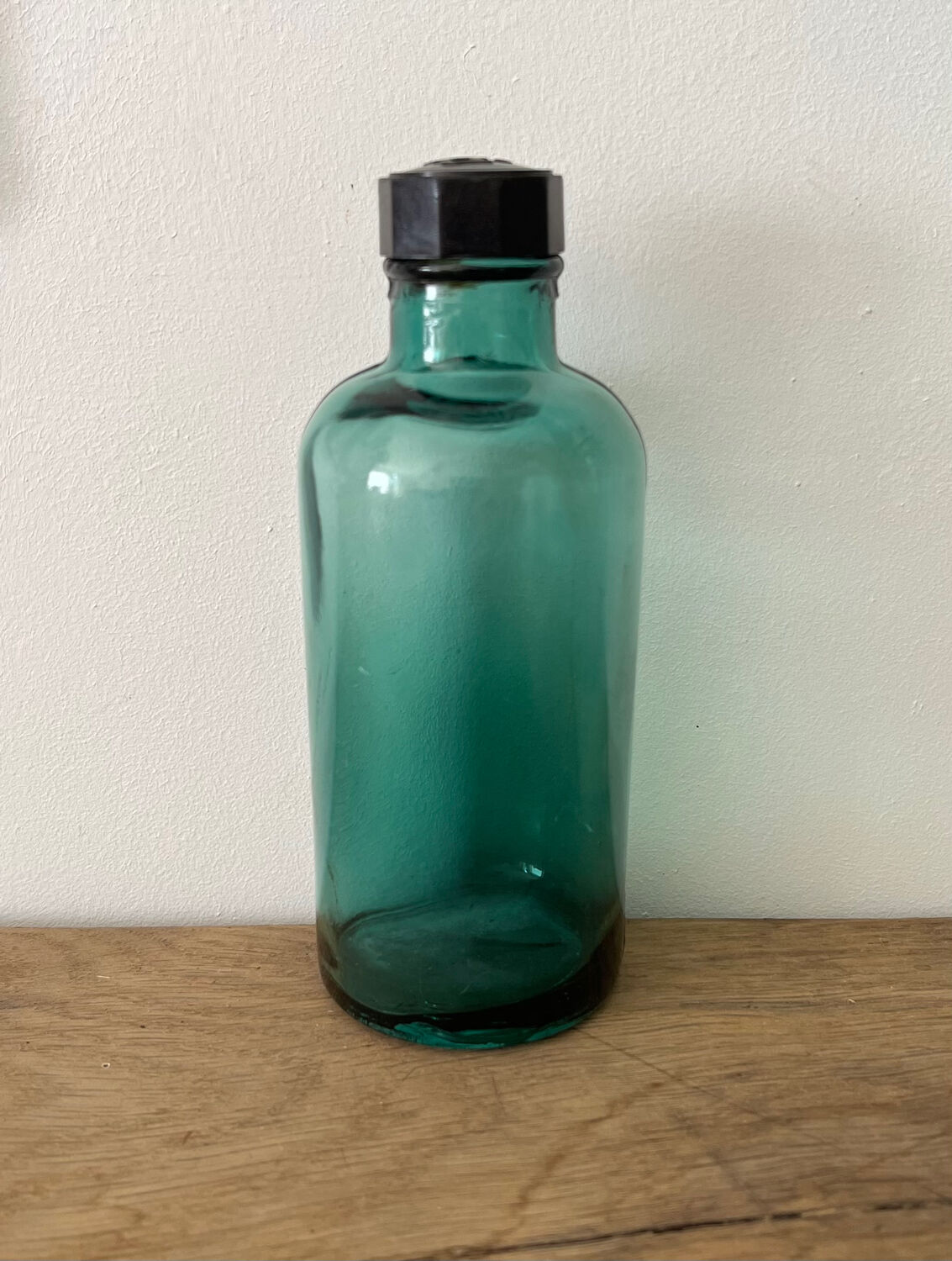 Small vintage dark turquoise blue bottle