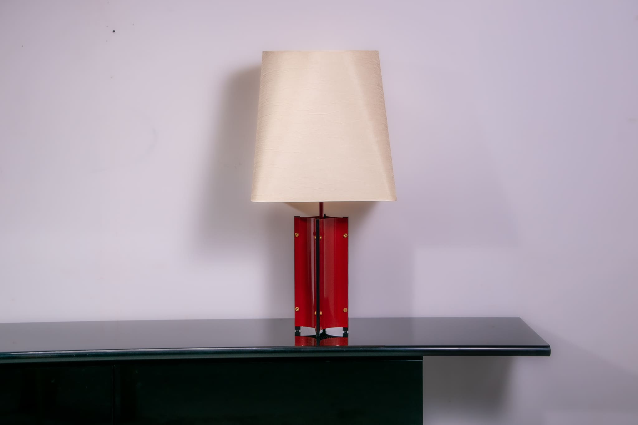Red metal sculptural table lamp with oversized lamp shade circa 1980