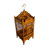 Old bird cage in carved wood and wicker