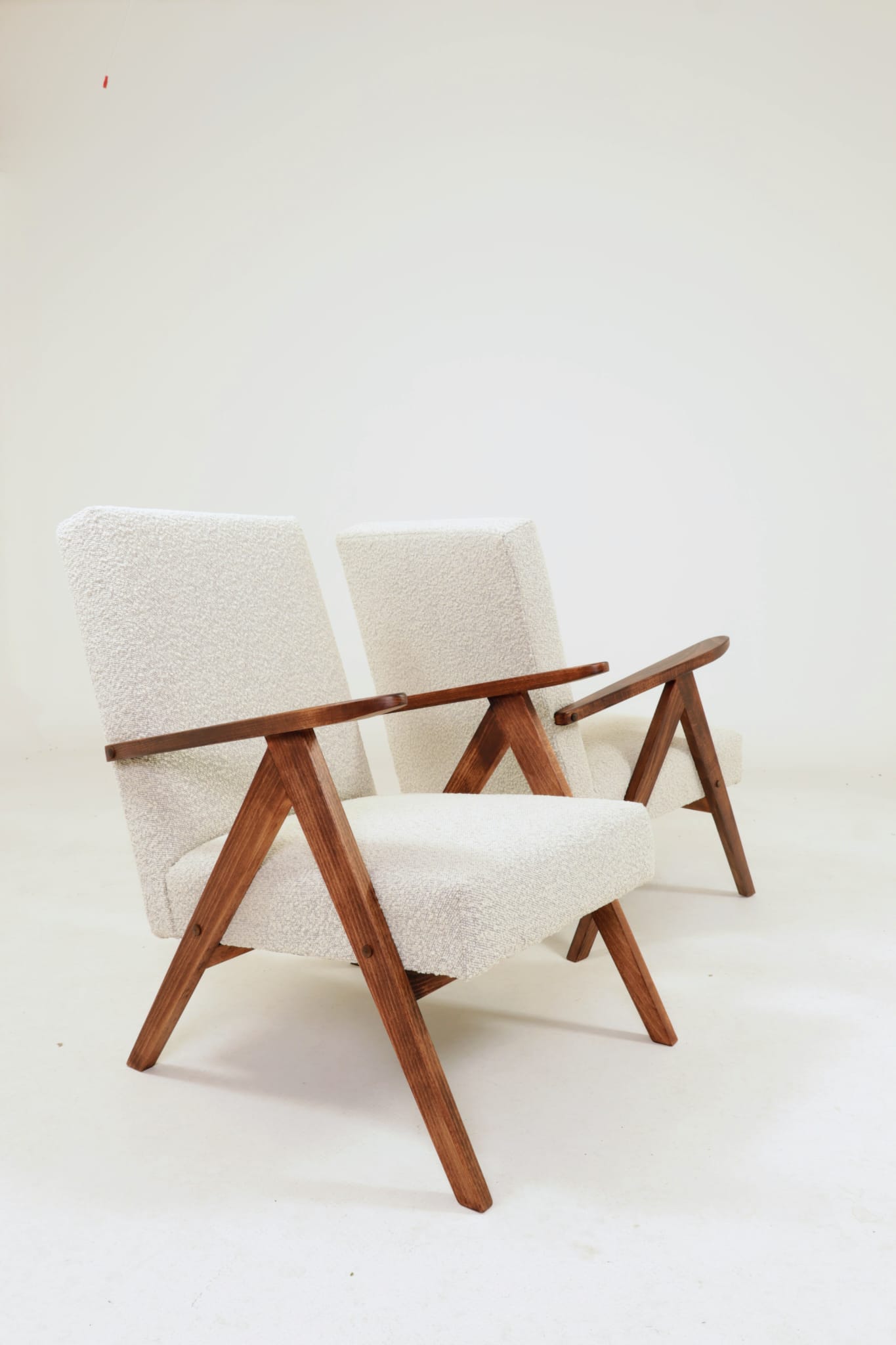 Pair of Mid-Century Modern armchairs in solid beech and boucle fabric.
