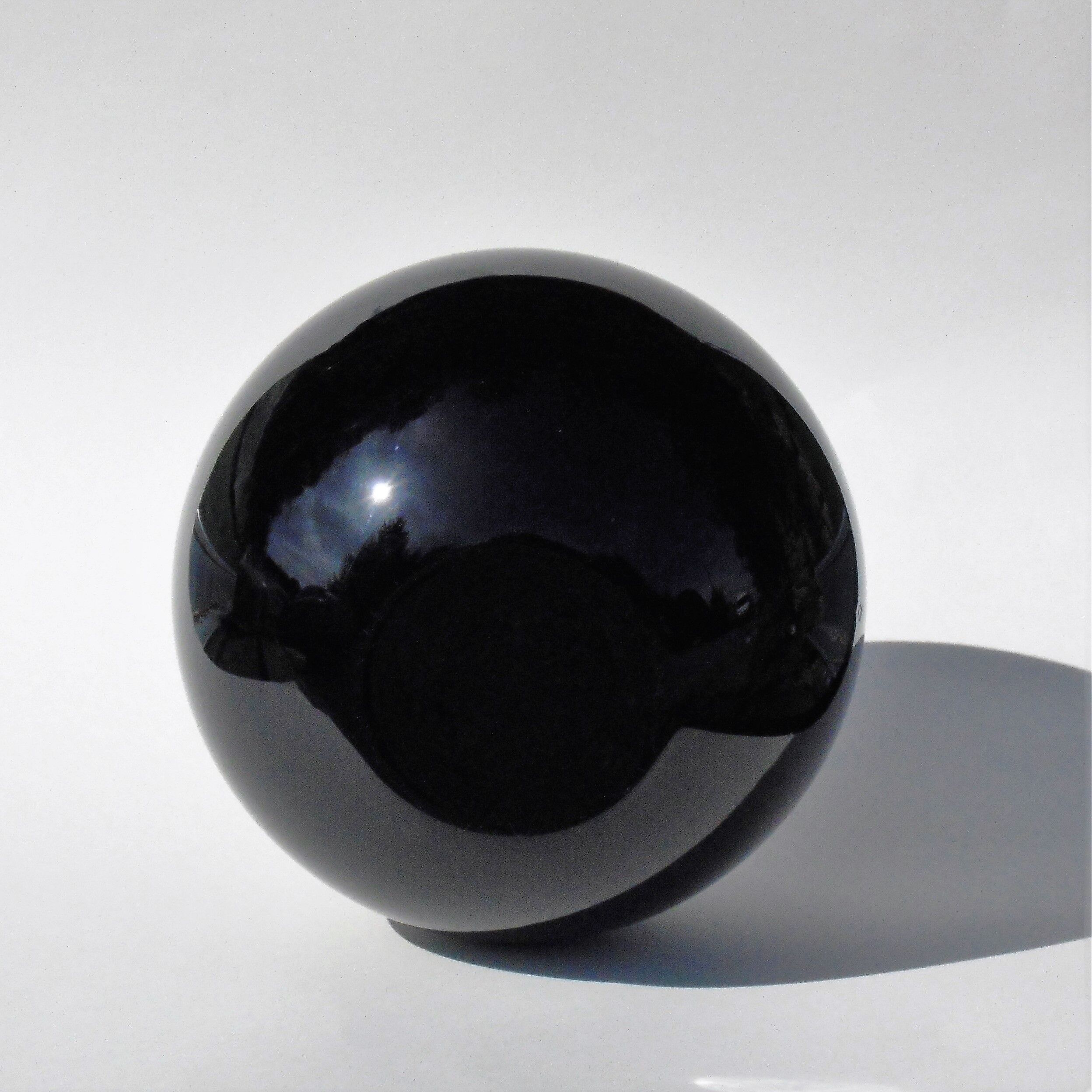 Old lamp foot shaped ball in black glass