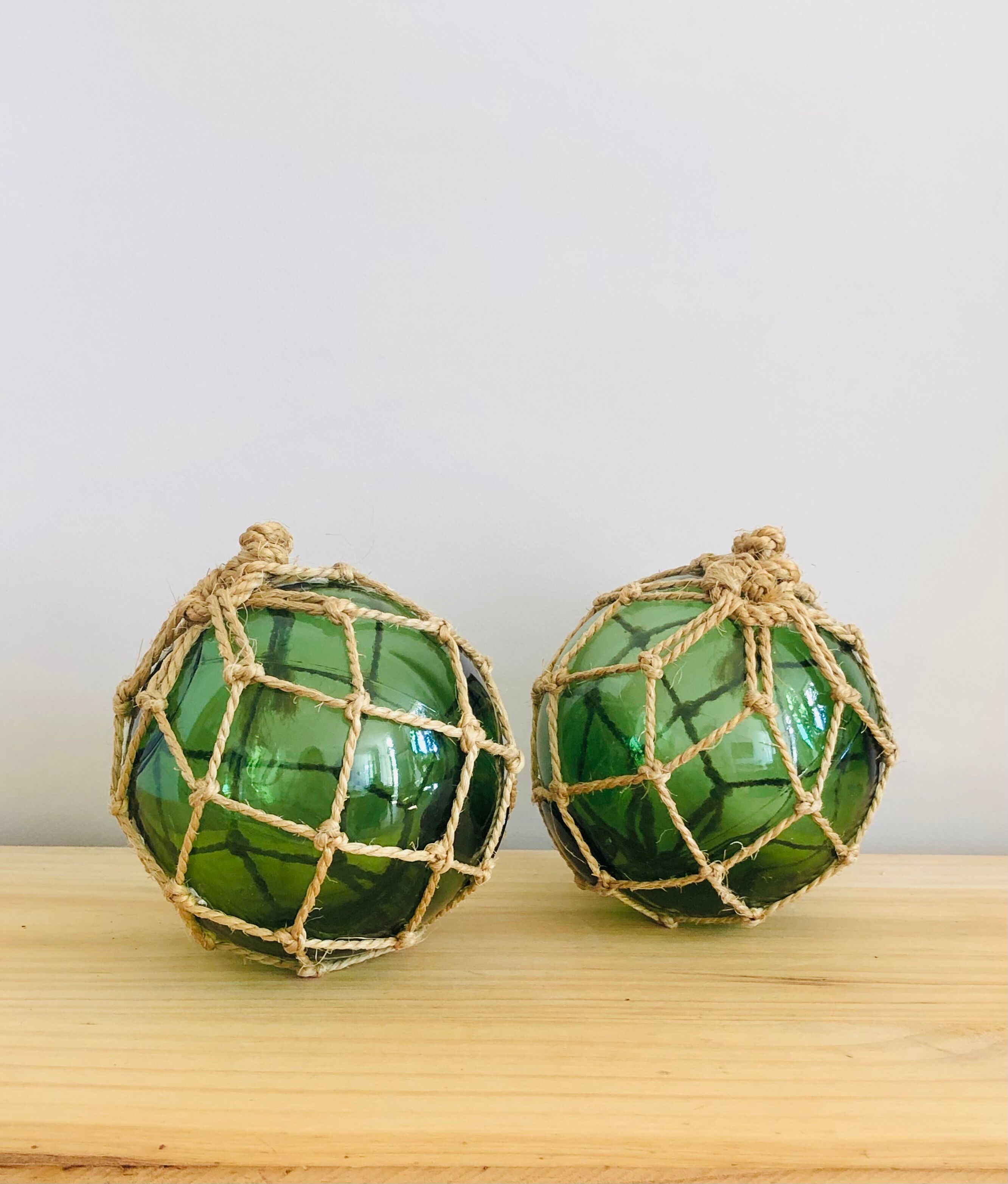 Pair of fishing floats and glass and rope