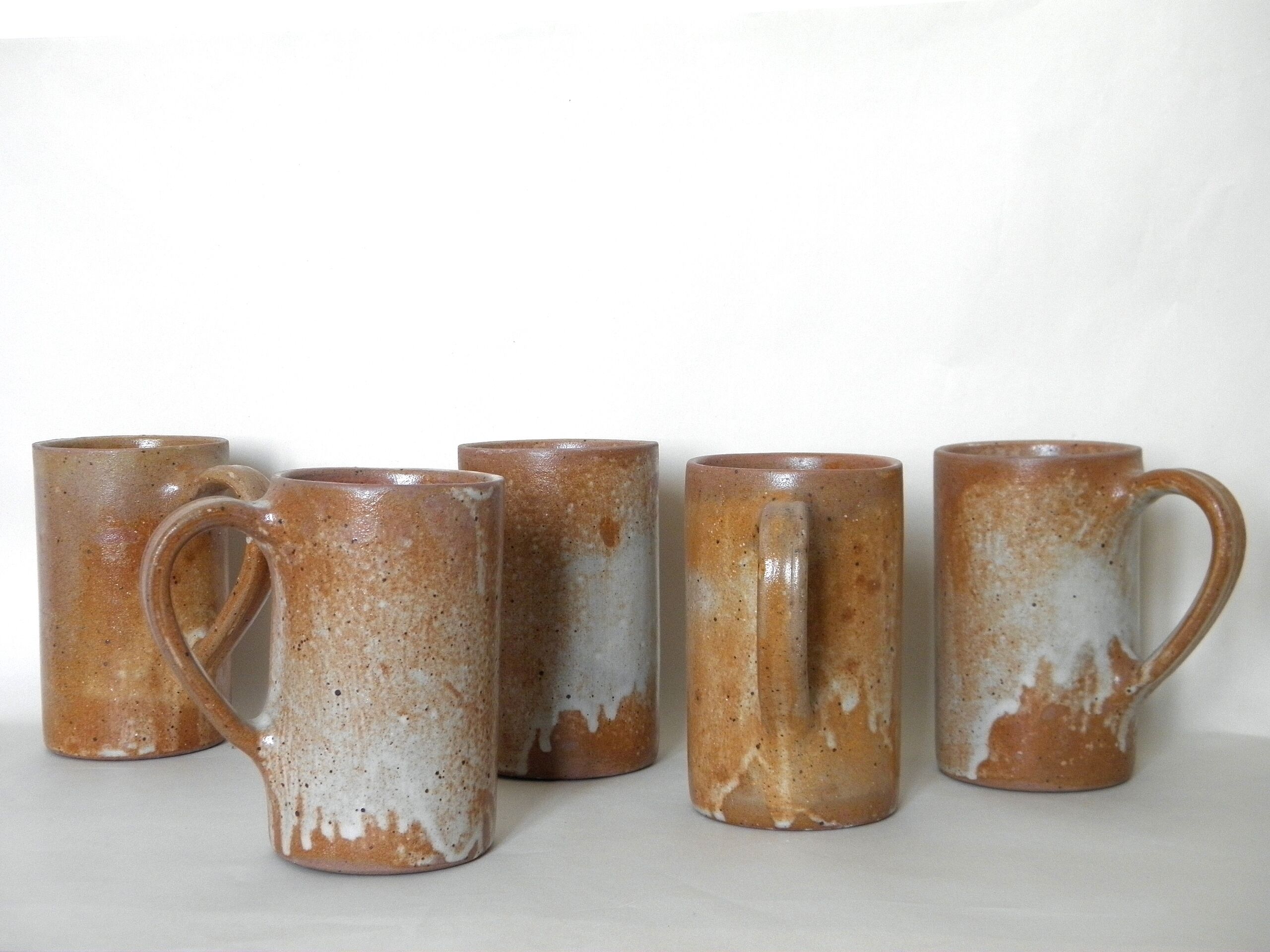 Decanter and enamelled stoneware mugs