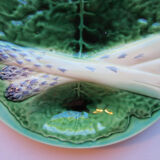 Asparagus plate in dabbling, with a leaf of green cabbage
