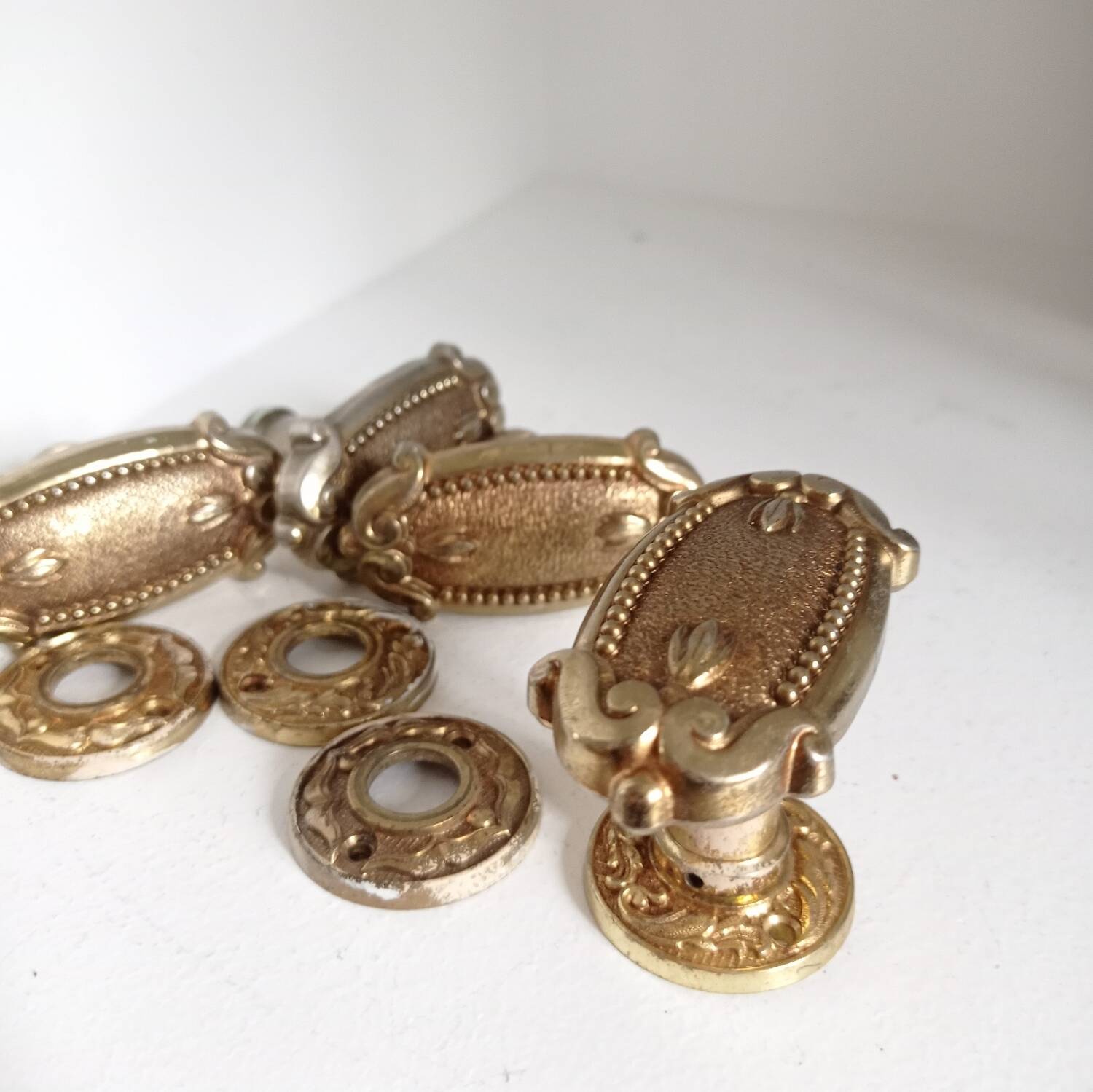 Gold door knobs and rosettes