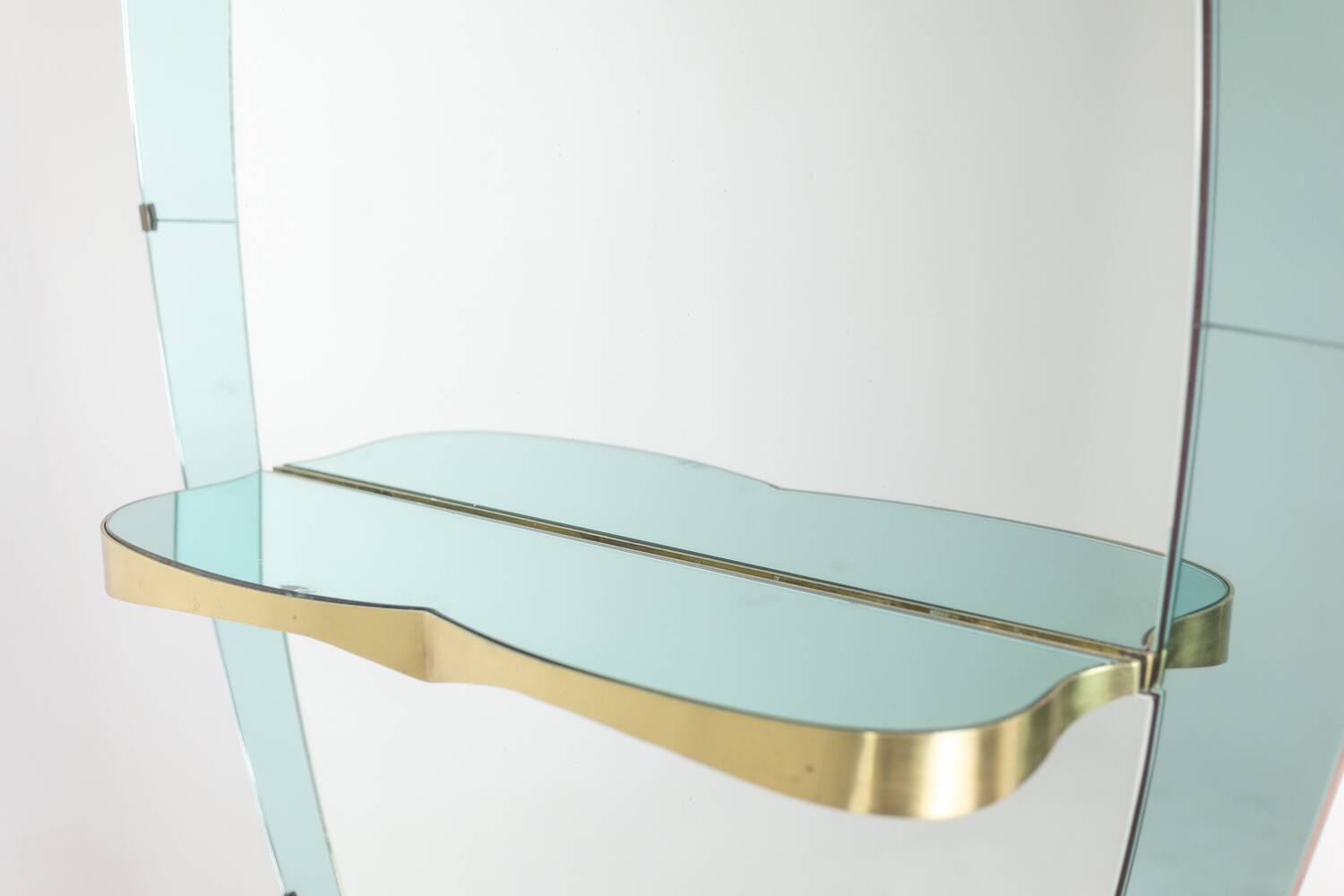 Two-tone glass and gilded brass console mirror. Circa 1950.