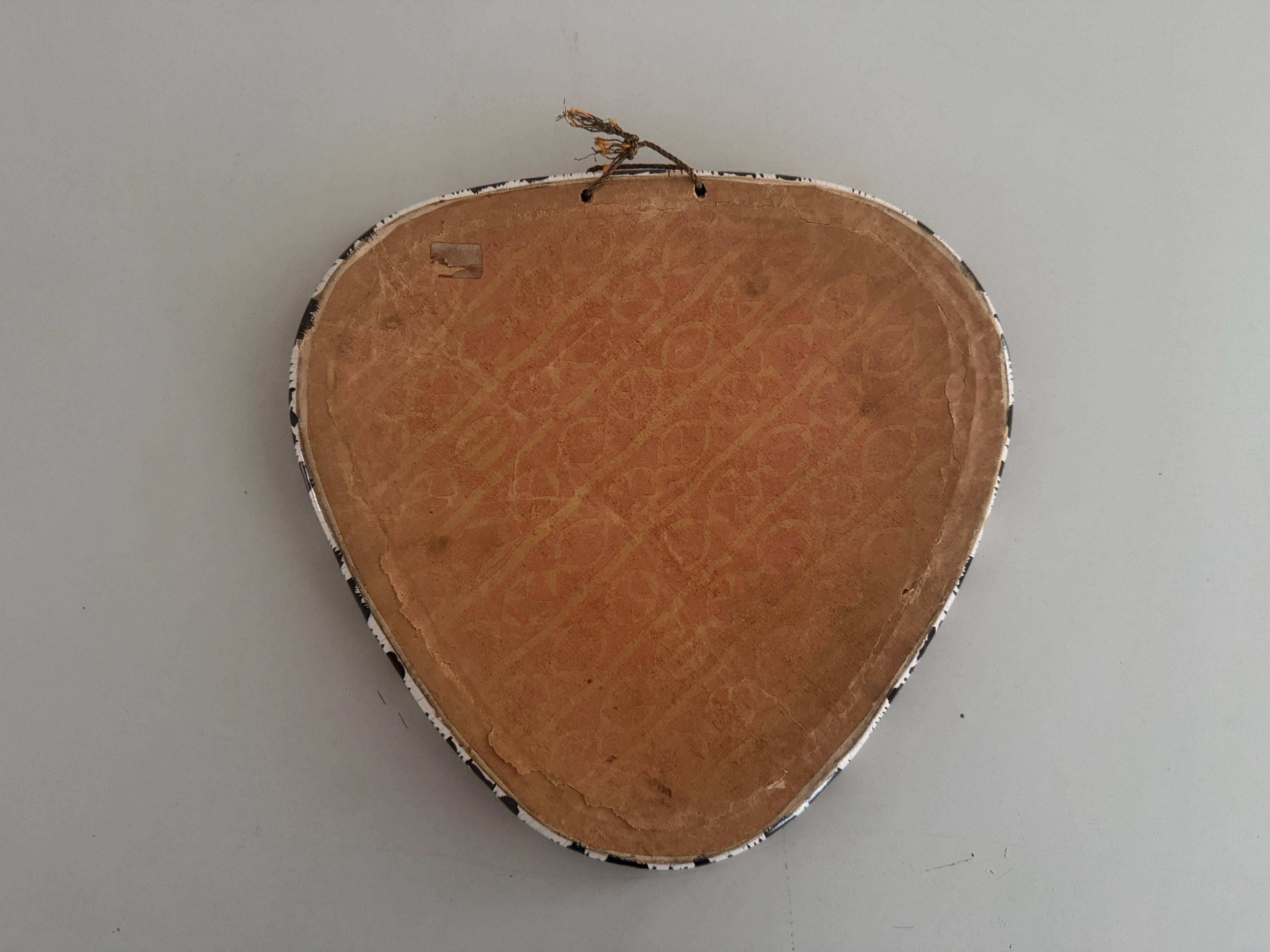 Small wall mirror, round triangle in black and white ceramic, 1950s, Germany.