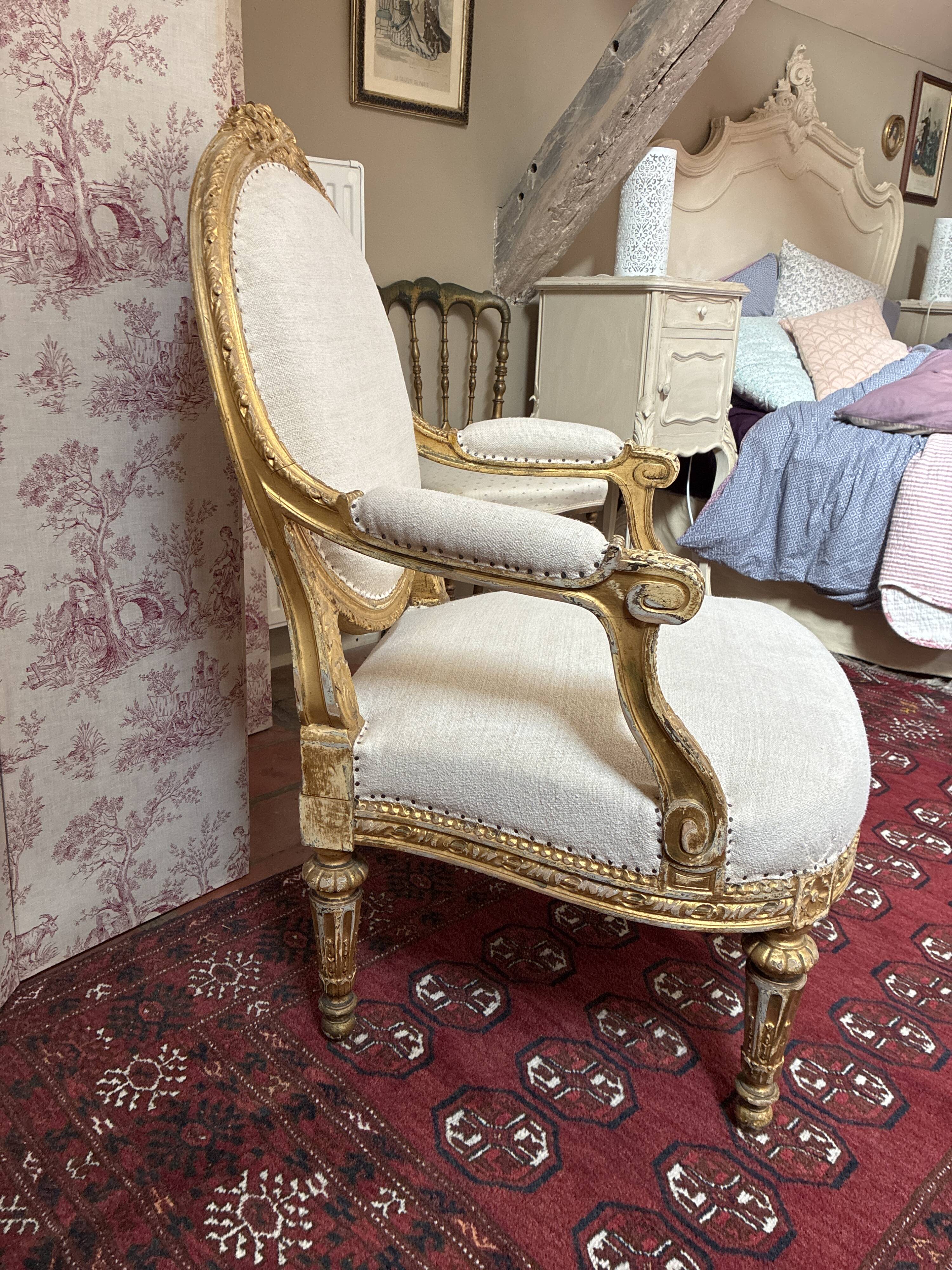 Large cabriolet armchair in Louis XVI style with gilded wood.