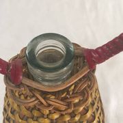 Bottle sheathed on the top and the low d wicker woven