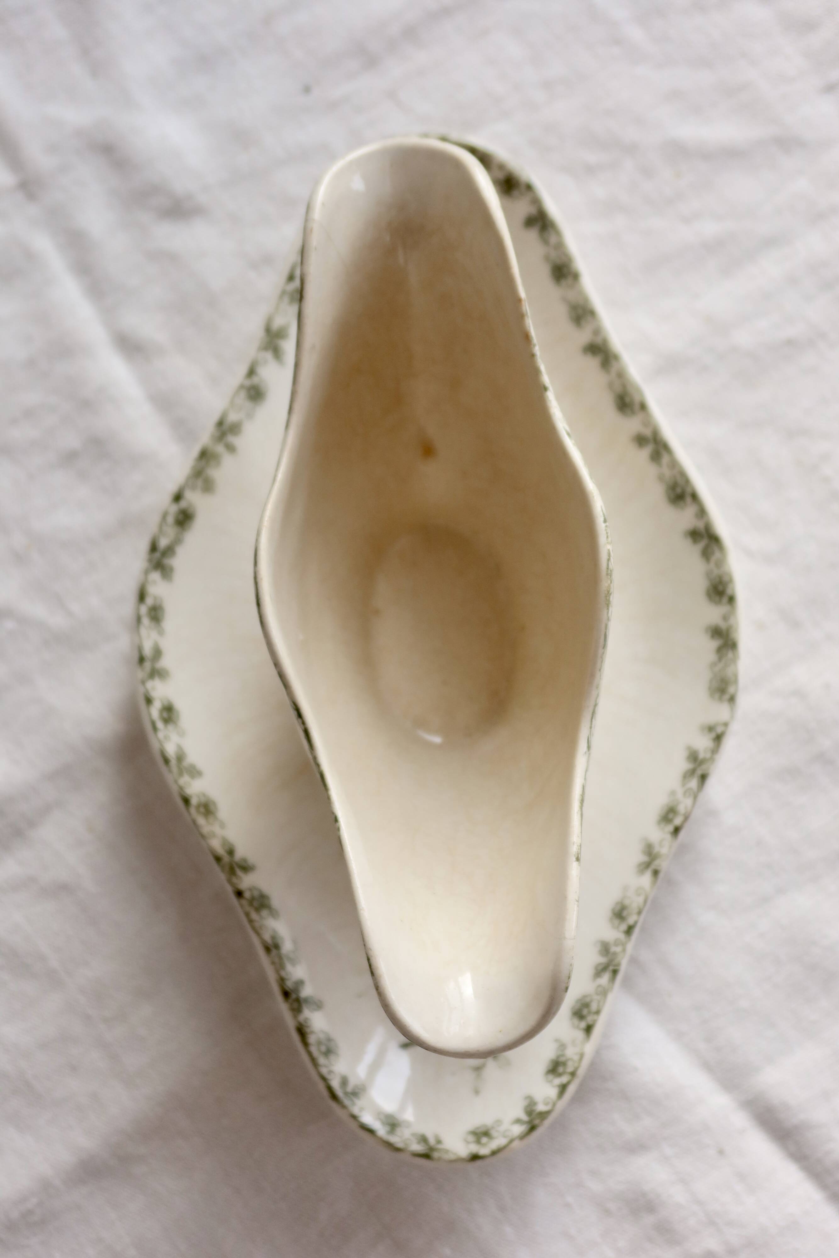 Antique sauce boat, ironstone, ivory with green floral and butterfly decoration.