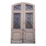 Porte d'entrée cintrée double en chêne, grilles et verre, XIXème