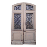 Porte d'entrée cintrée double en chêne, grilles et verre, XIXème