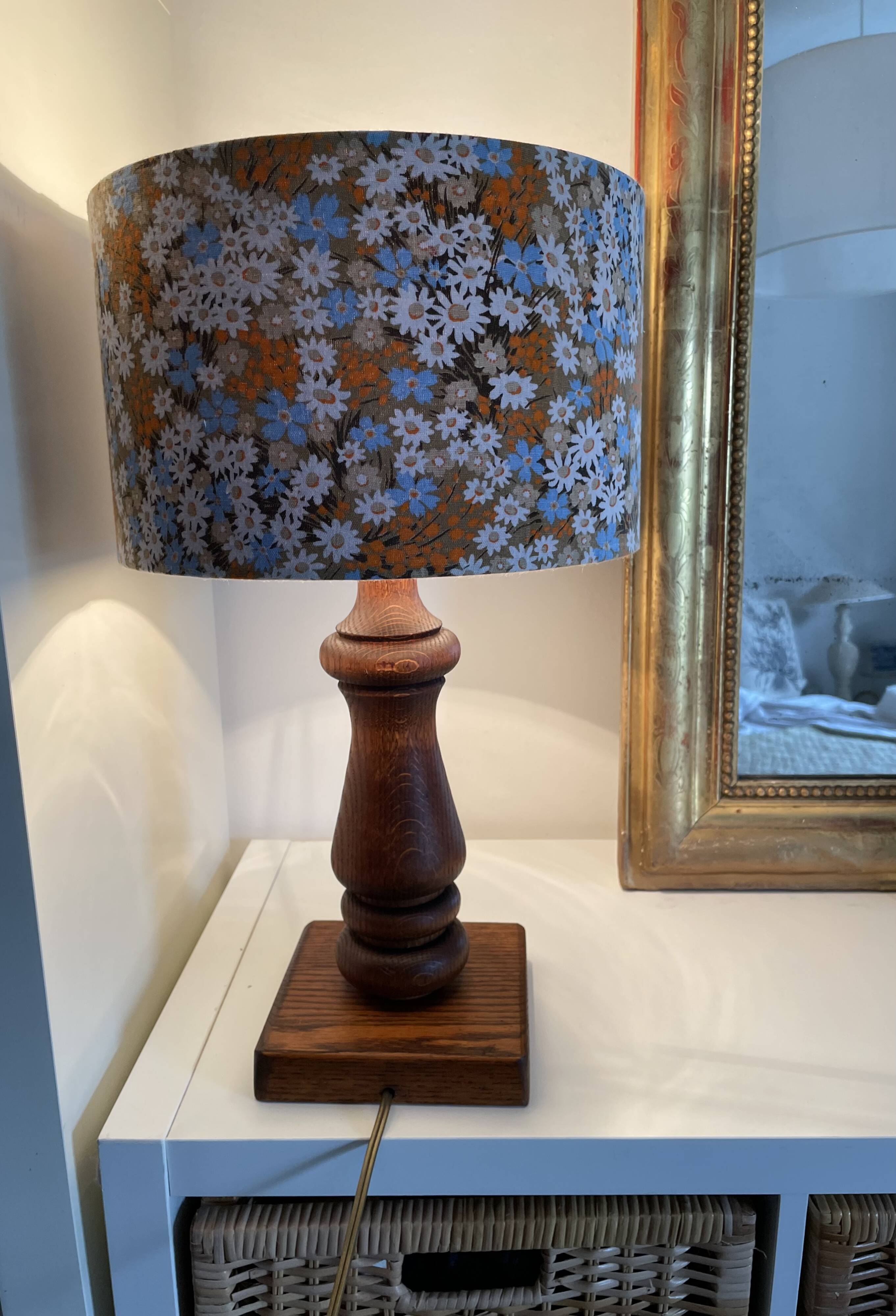 Vintage turned wood table lamp with floral drum shade.