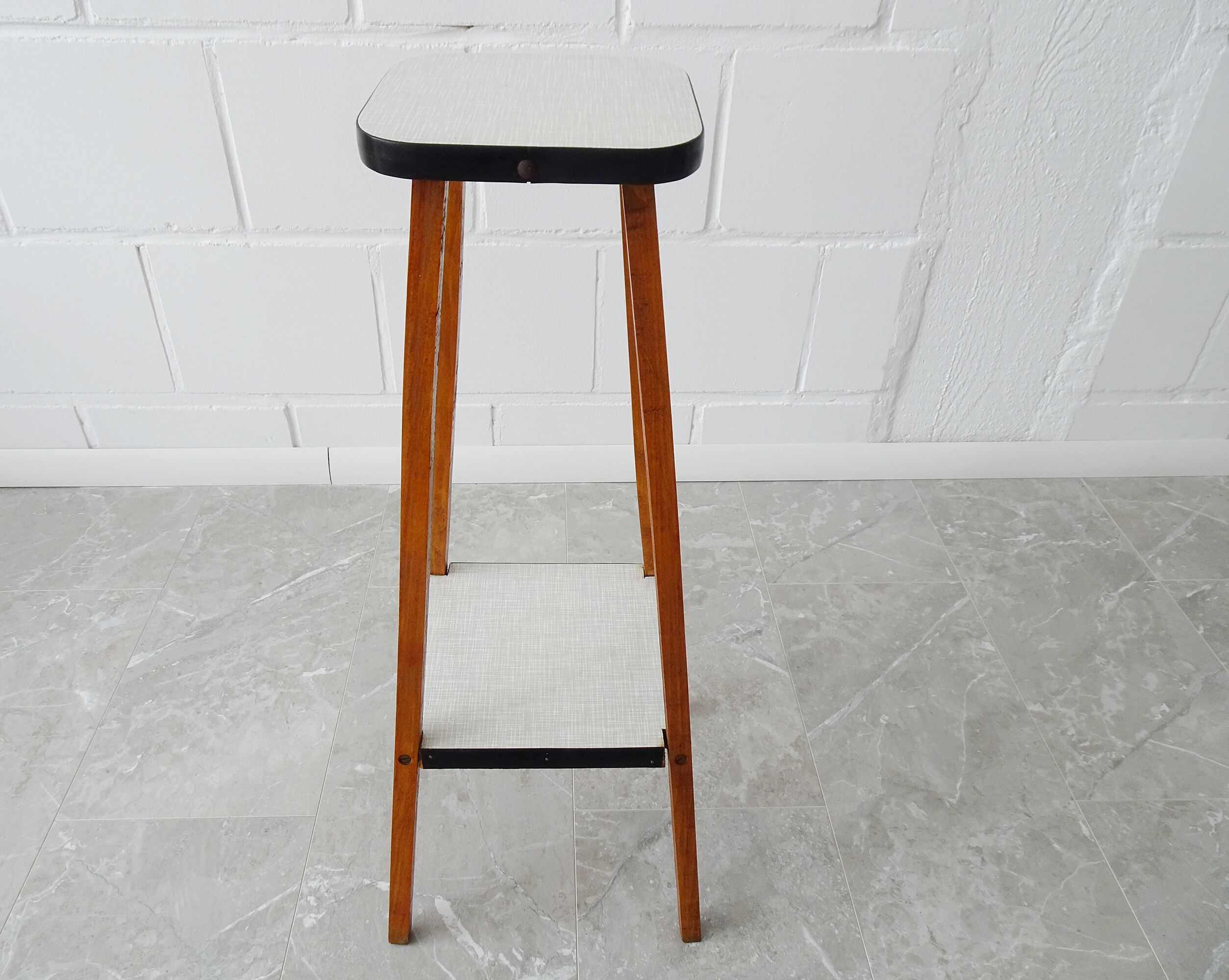 Plant stand made of wood and formica with two shelves, flower column