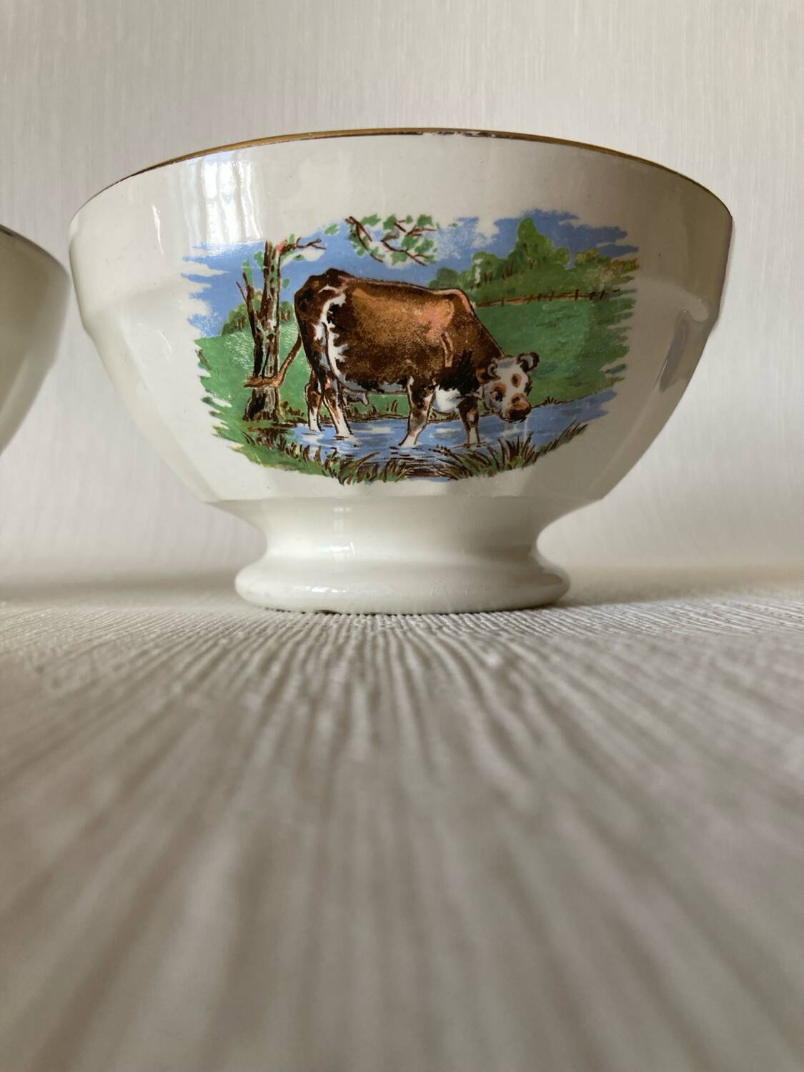 Pair of small faceted bowls with cow illustrations from the 40s and 50s
