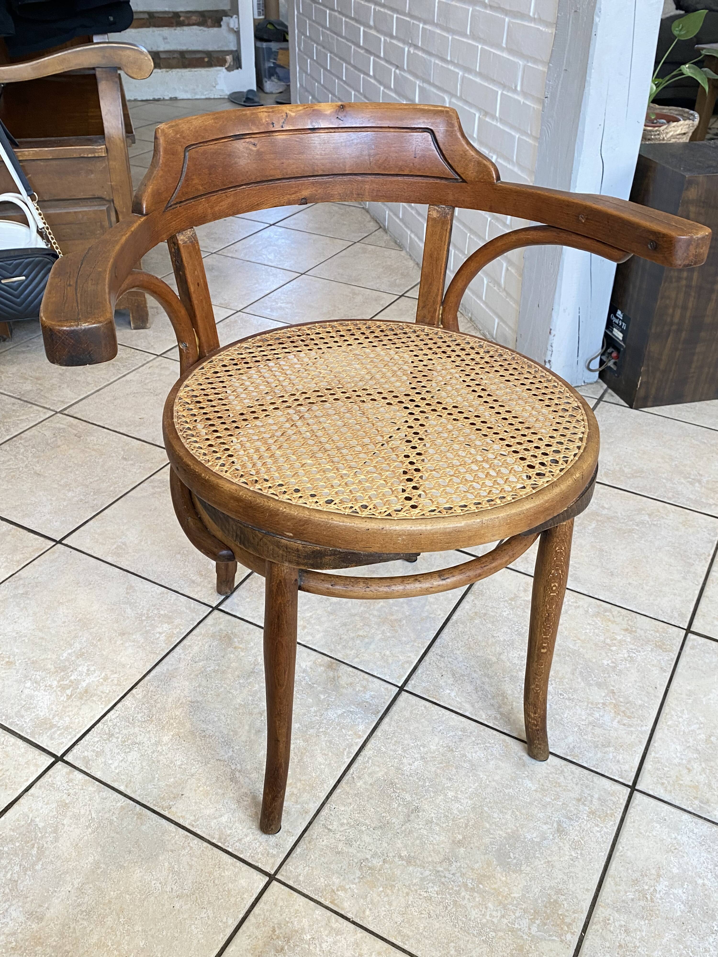 Bistro chair with a curved wooden frame and caned seat from the 1930s.