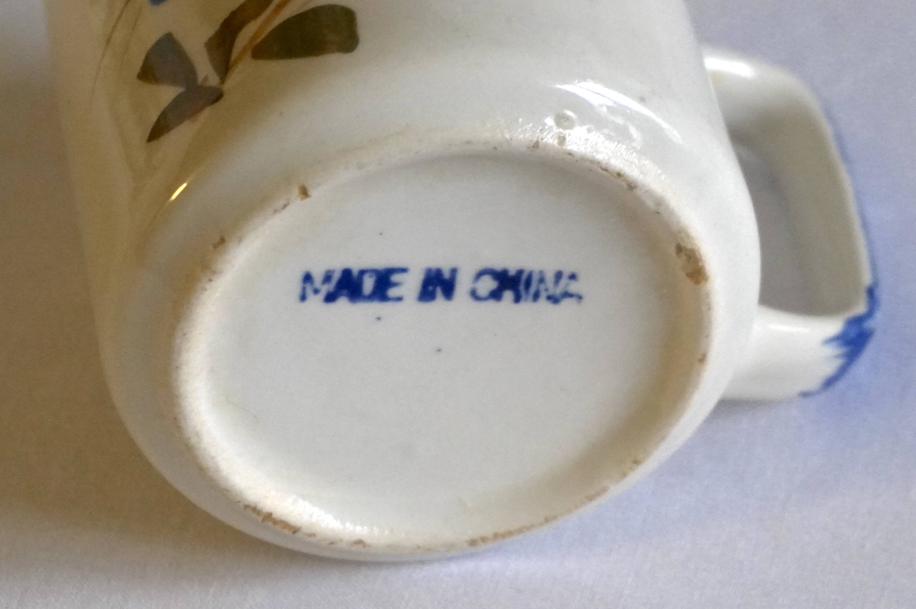 Set of 4 stoneware cups/mugs with blue floral designs, made in China.