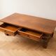 Antique solid wood coffee table with drawers.