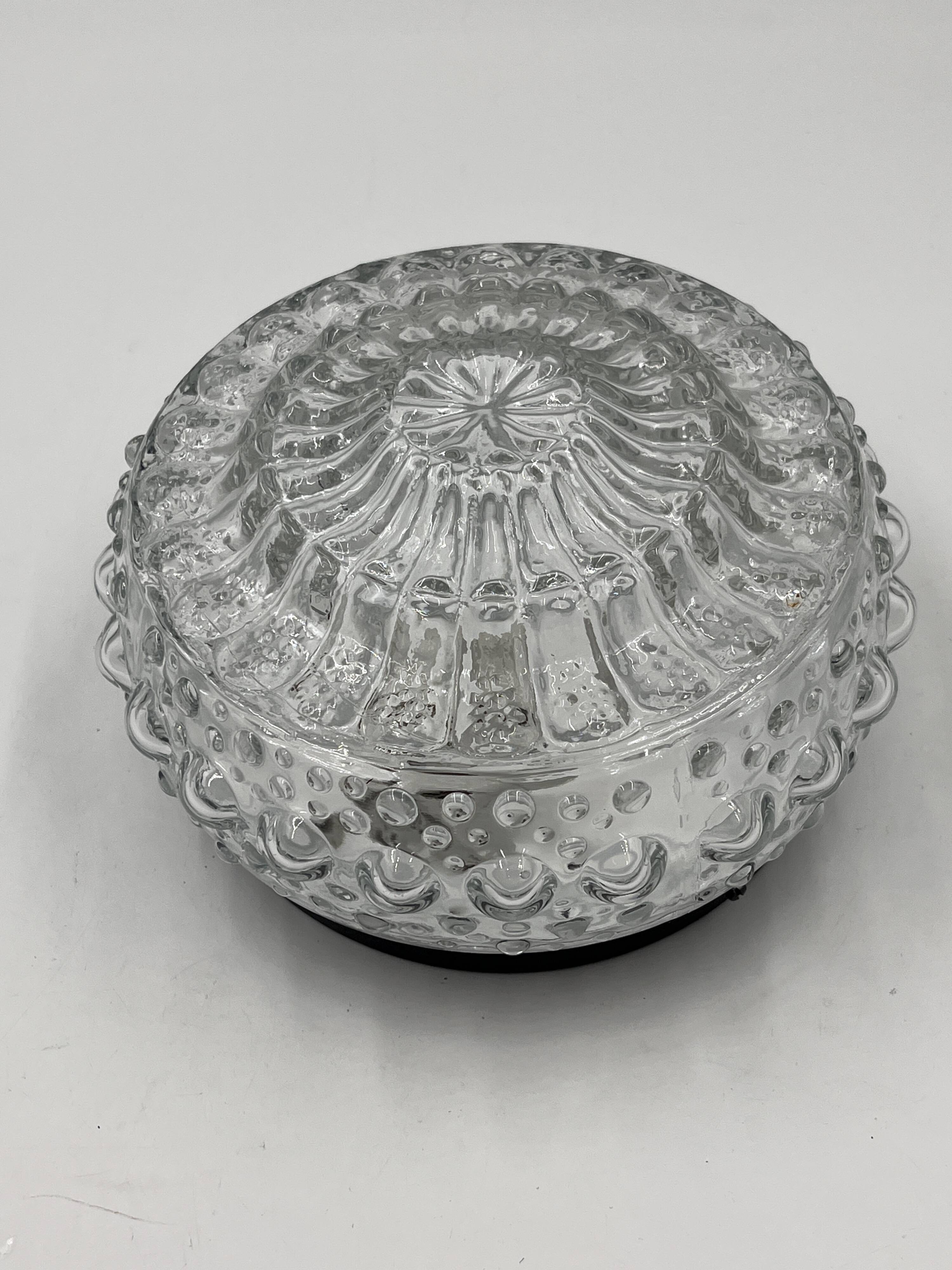 Molded glass ceiling light with spinning top relief