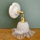 Vintage tulip glass wall light in transparent, slightly pearlescent white.