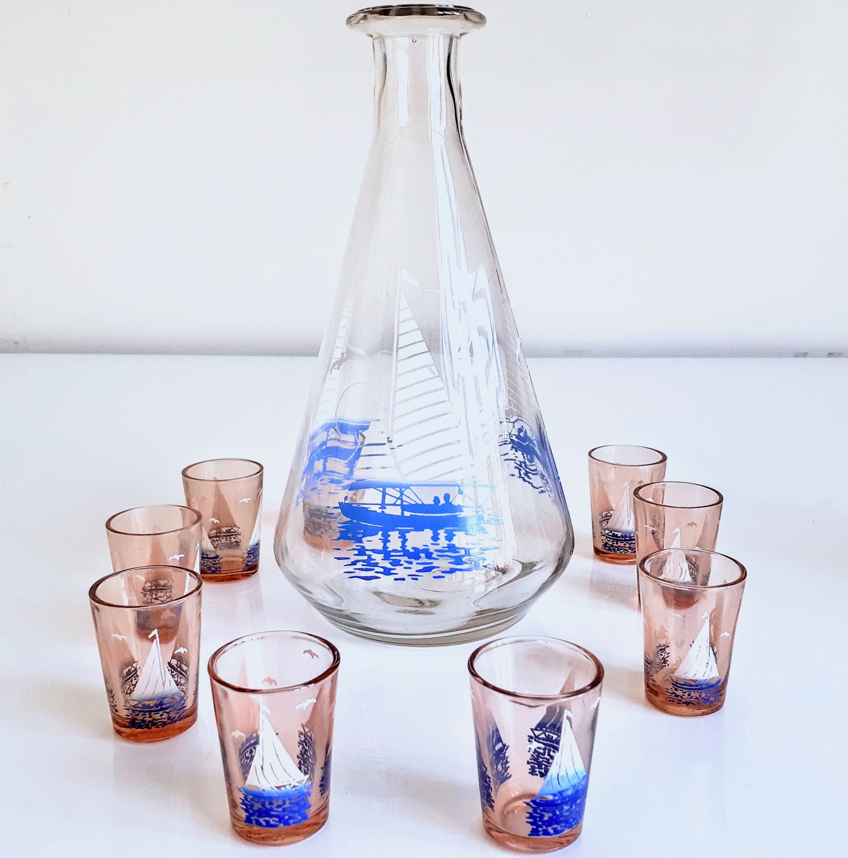 Carafe and 9 liquor glasses decorated with sailboats