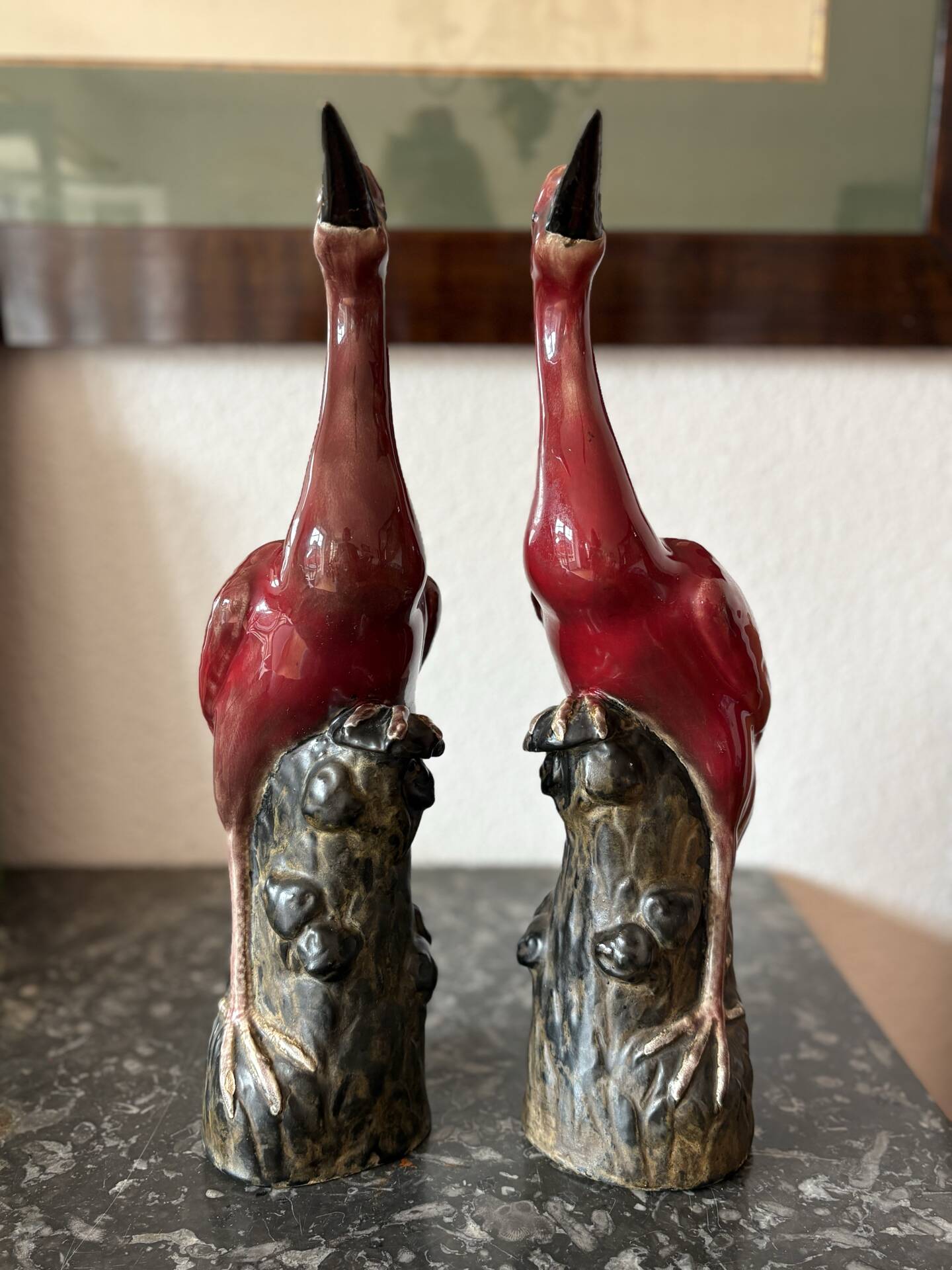Pair of ceramic red glazed wading bird (crane) figurines.