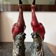 Pair of ceramic red glazed wading bird (crane) figurines.