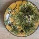 Four antique dessert plates in majolica with vine decoration.