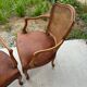 Cane and leather armchair in Louis XV style