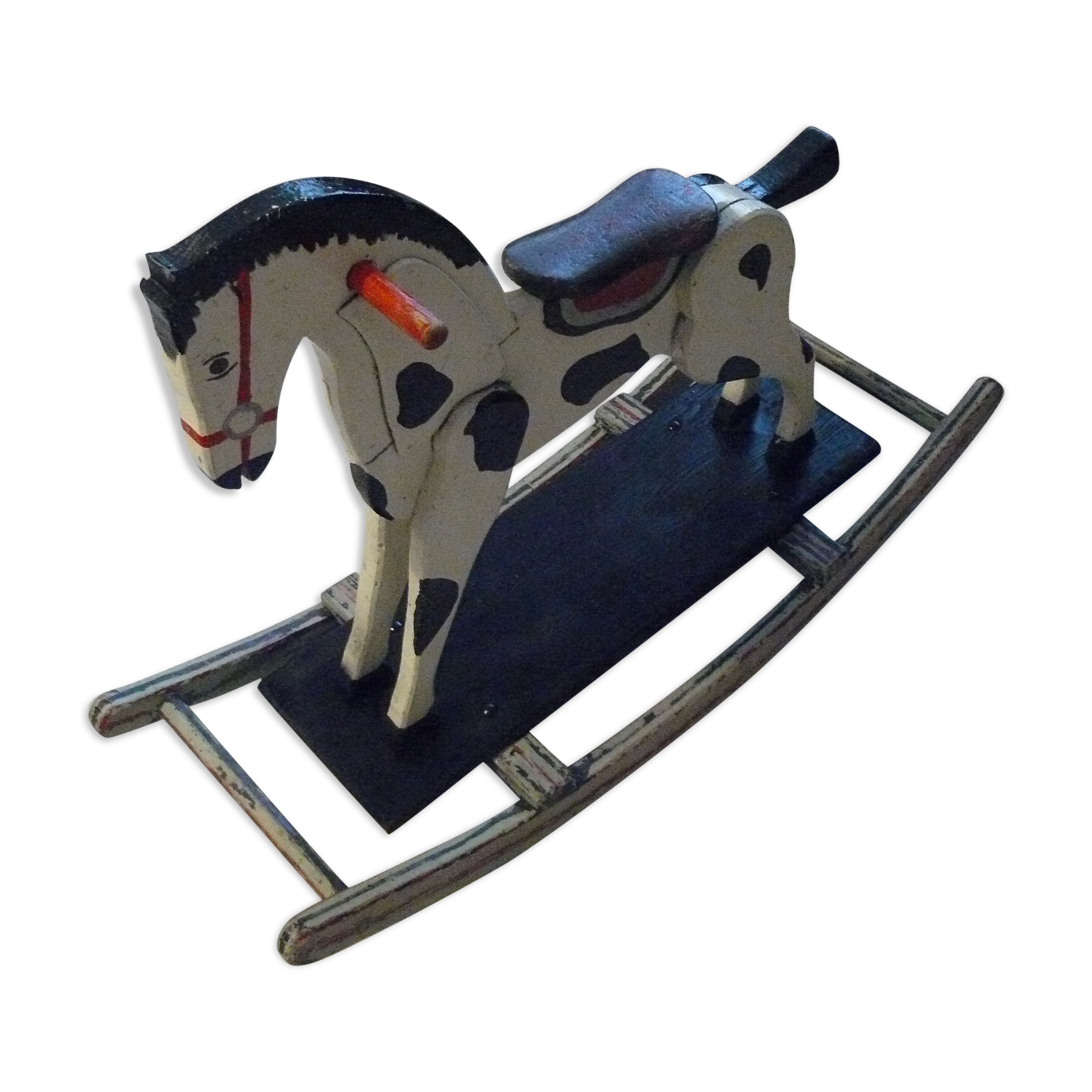 Old rocking horse in painted wood