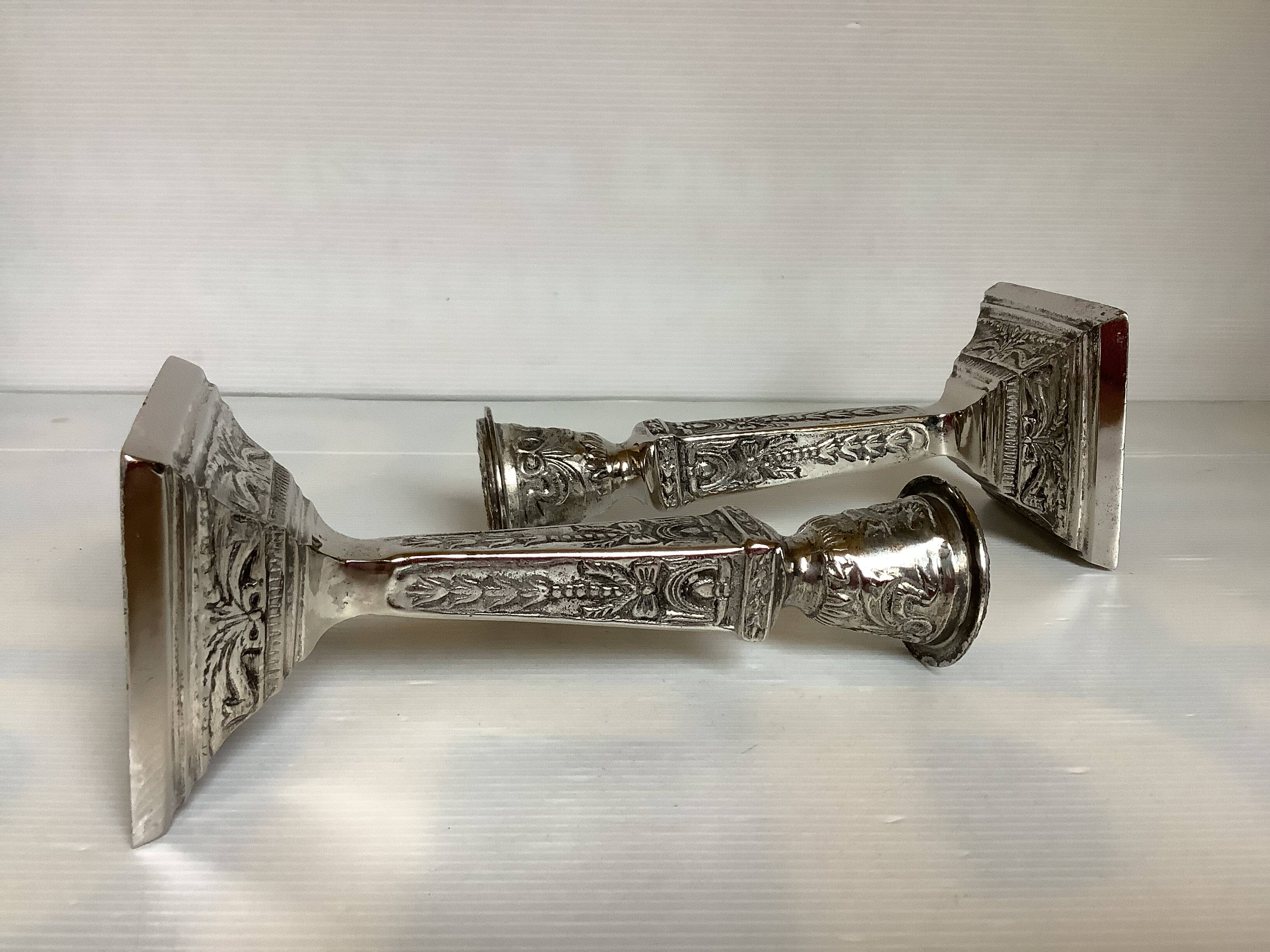 Pair of ornate silver candlesticks