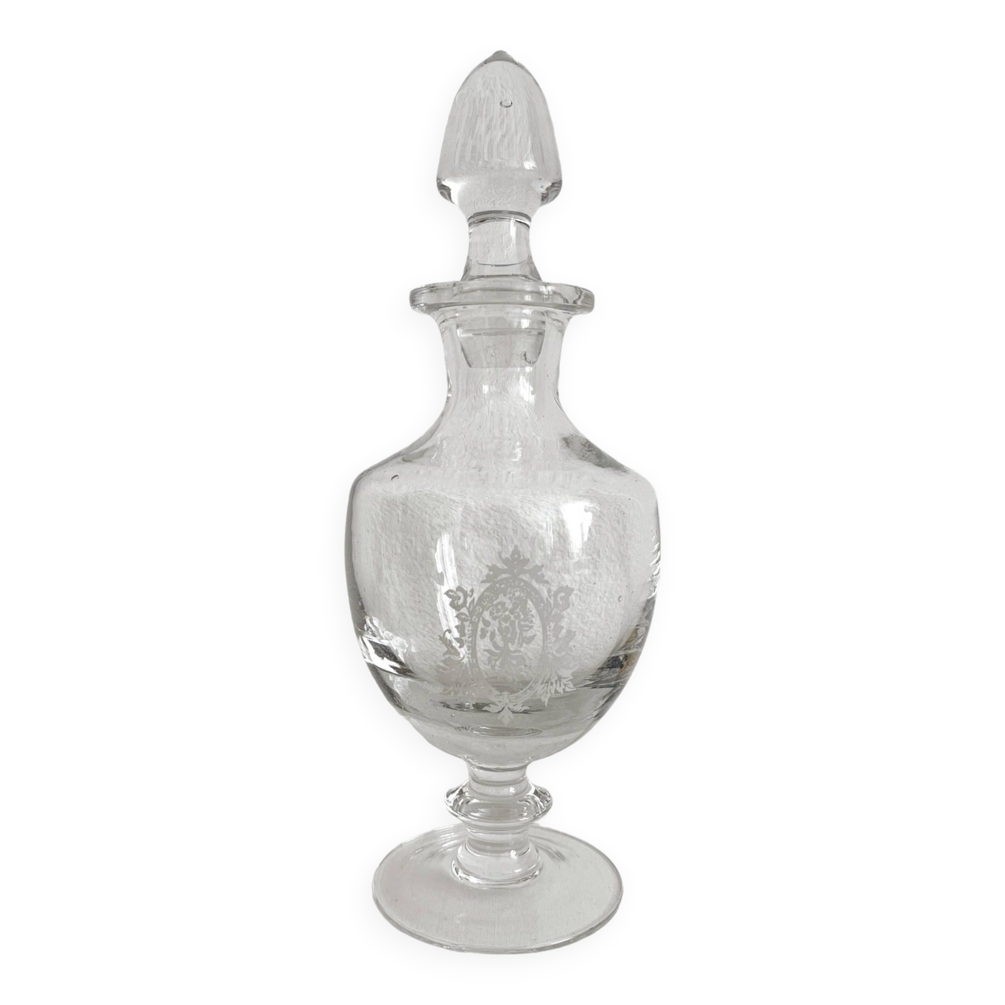 Antique stemmed blown glass bottle with engraved medallion