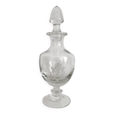Antique stemmed blown glass bottle with engraved medallion