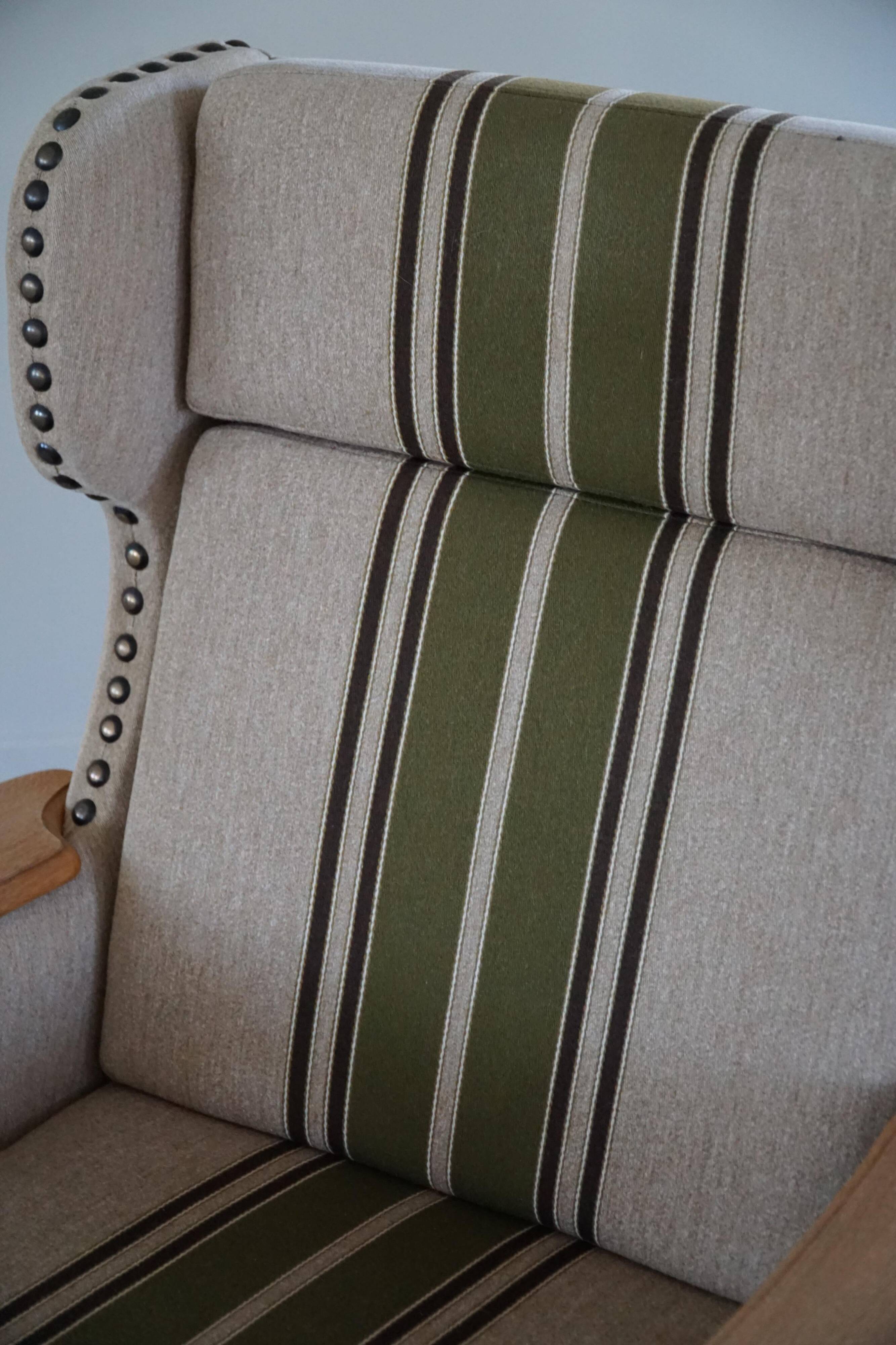 Pair of high-back lounge chairs in modern Danish style in the manner of Henning Kjærnulf, 1960s.