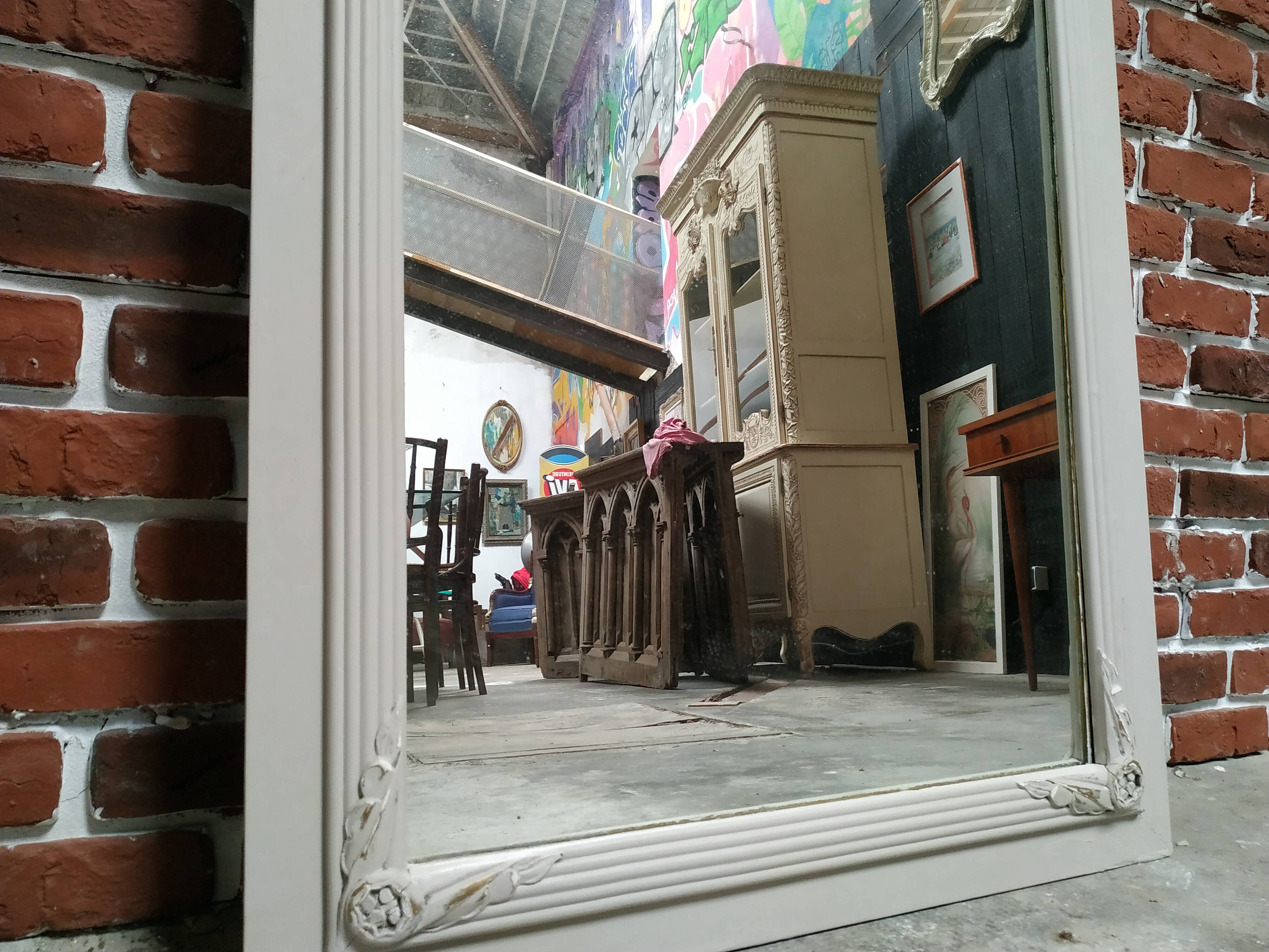 White and gold patinated sculpted mirror