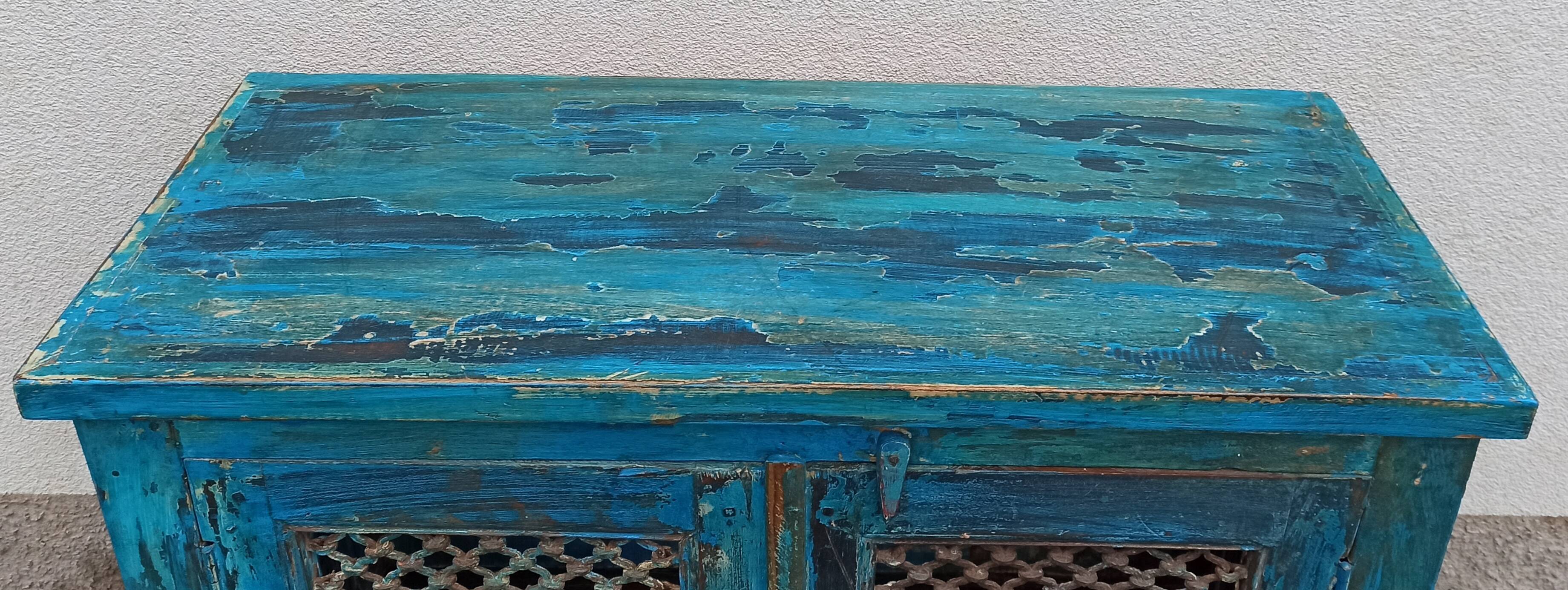 Old wooden cabinet with doors with grille