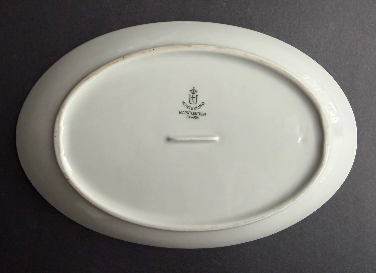 4 small oval porcelain dishes