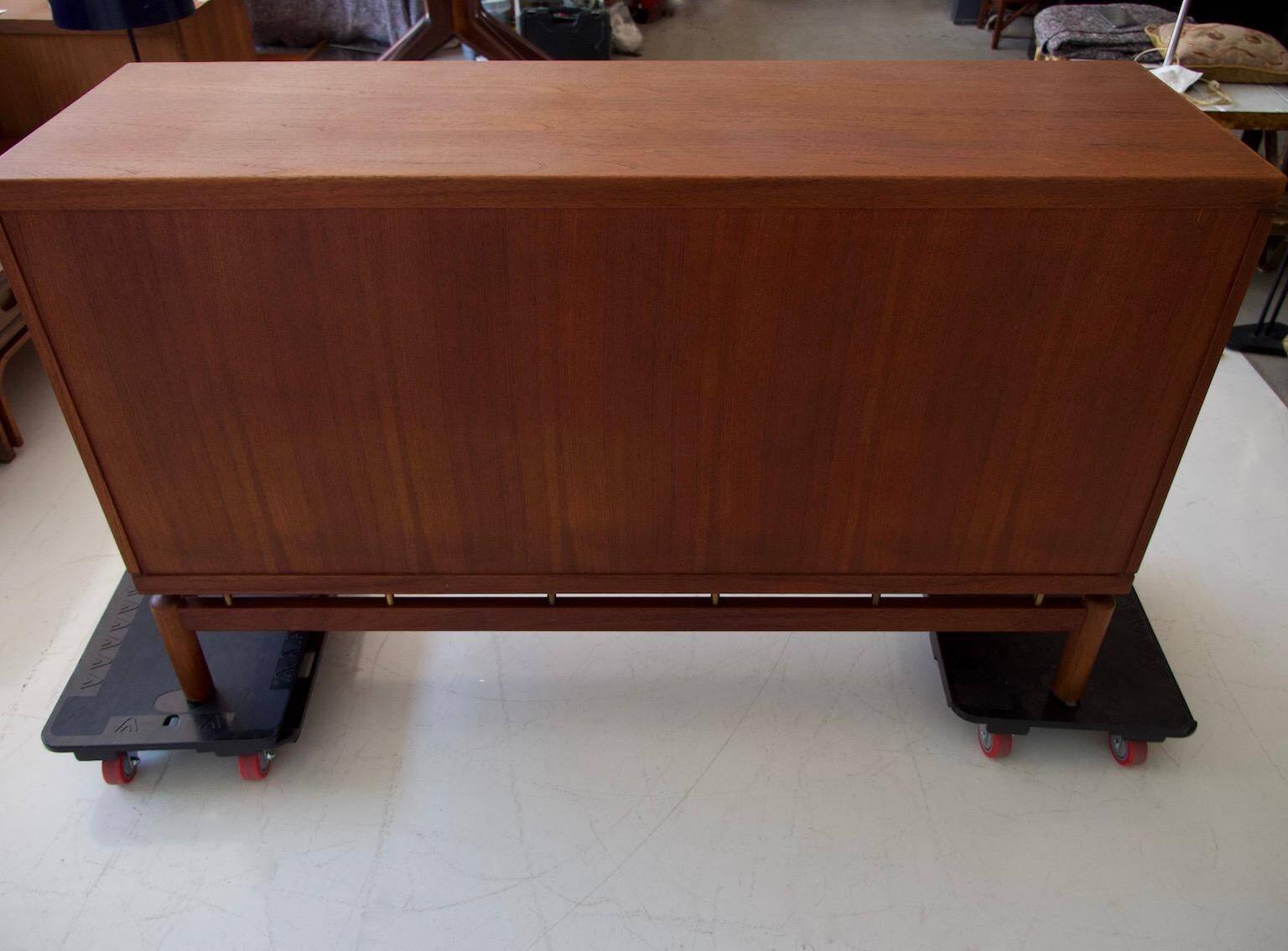 Modern mid-century teak sideboard with brass details.